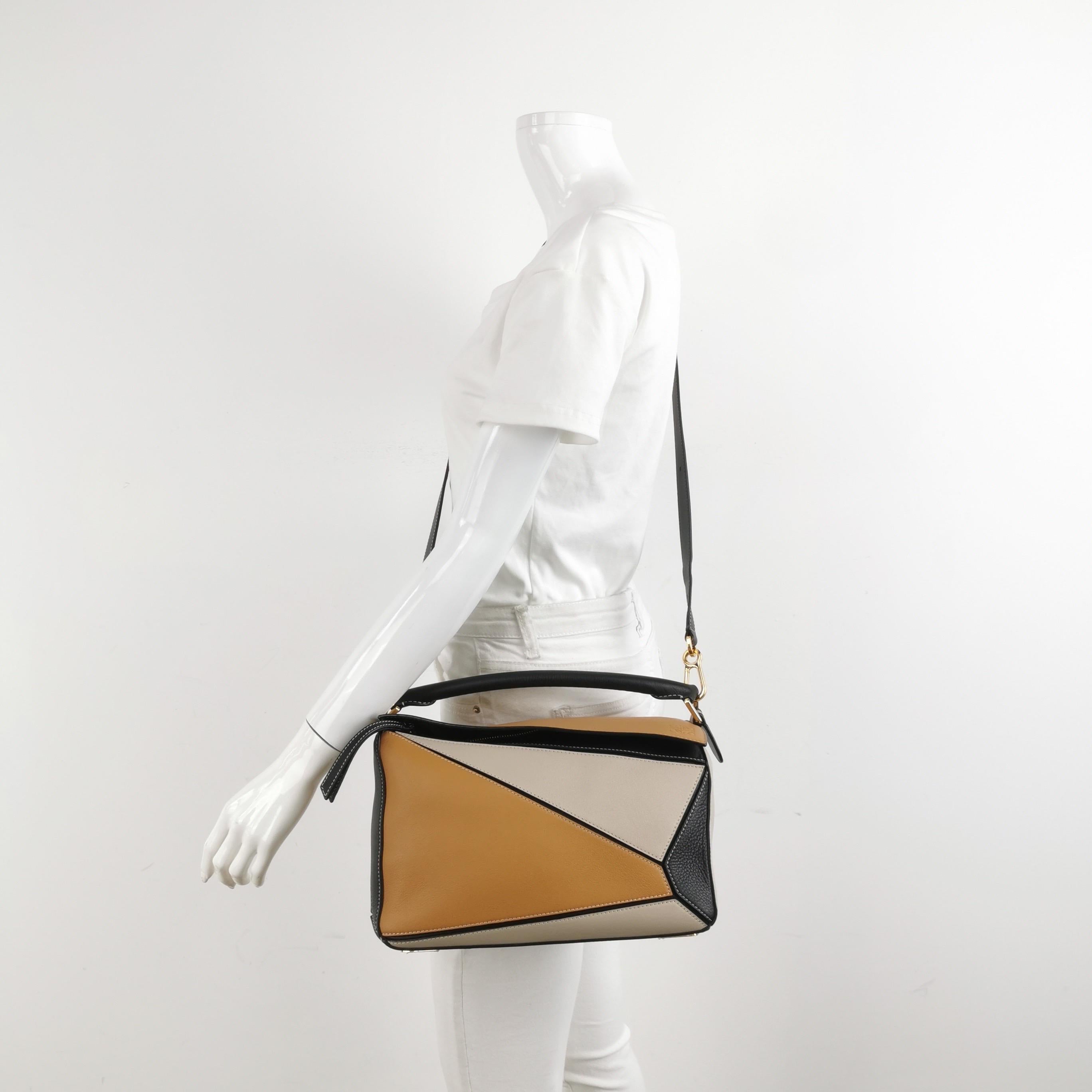 Loewe's Puzzle bag is a timeless classic cult piece. Crafted from supple calfskin leather and finished with silver hardware and signature origami-inspired panels, this bag is versatile and stylish. 

CONDITION: EXCELLENT

This preloved item is in