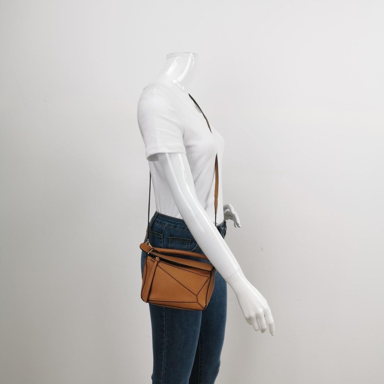 Loewe Puzzle Mini Caramel Tan Calfskin Leather Crossbody Bag
These are professional photos of the actual bag.
  
  Loewe's Puzzle bag is a timeless classic cult piece. Crafted from supple calfskin leather and finished with silver hardware and