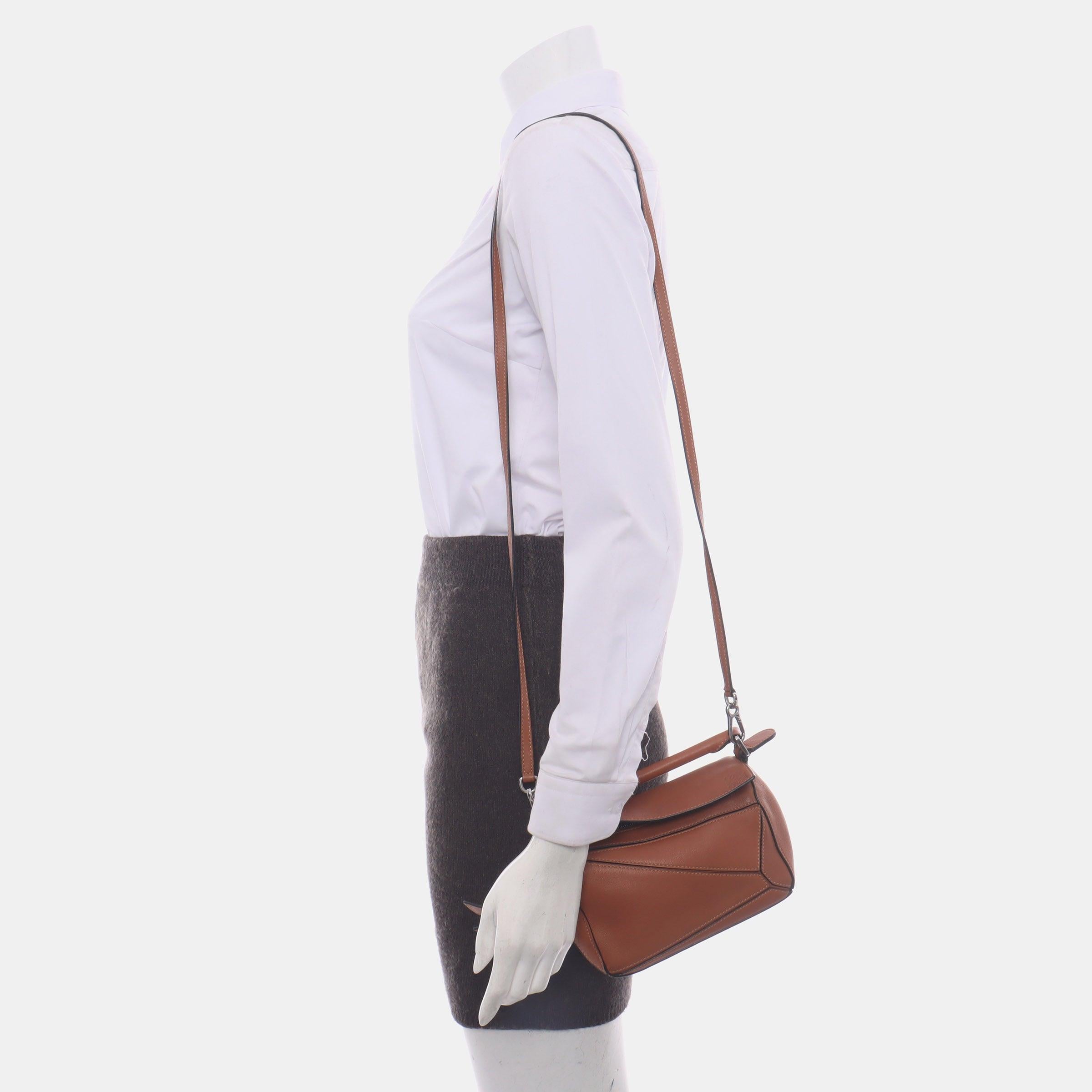 Loewe Puzzle Mini Caramel Tan Calfskin Leather Crossbody Bag
These are professional photos of the actual bag.
  
  Loewe's Puzzle bag is a timeless classic cult piece. Crafted from supple calfskin leather and finished with silver hardware and