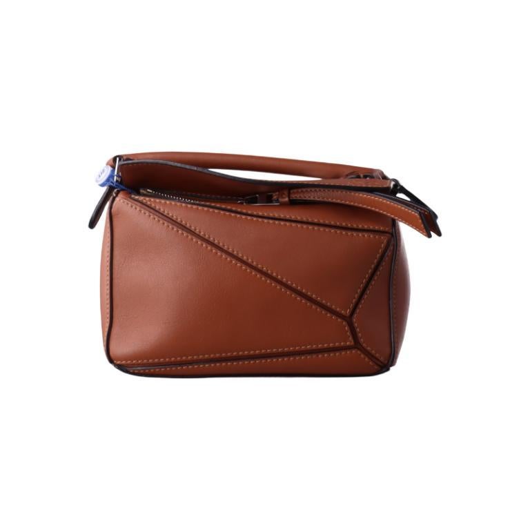 Loewe Puzzle Mini Caramel Tan Calfskin Leather Crossbody Bag
These are professional photos of the actual bag.
  
  Loewe's Puzzle bag is a timeless classic cult piece. Crafted from supple calfskin leather and finished with silver hardware and