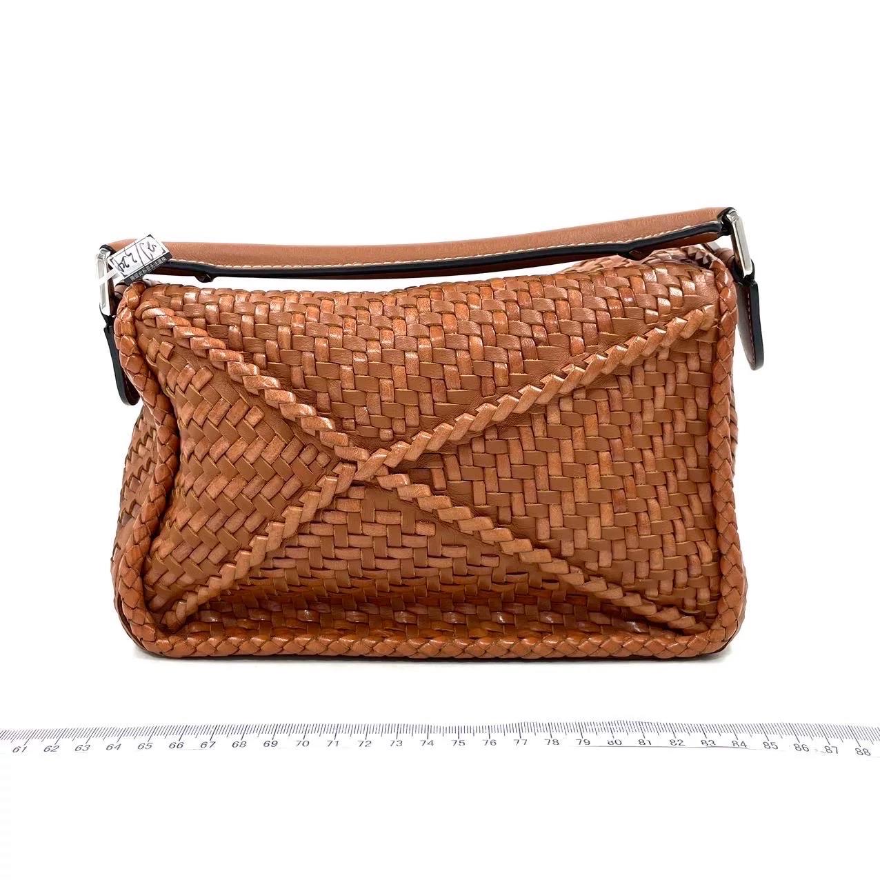 Loewe Puzzle Small Leather Woven Braided Navy Crossbody Bag
 These are professional photos of the actual bag.
 
 Expertly crafted from premium calfskin leather, this crossbody bag is meticulously woven together from strips of the same material. The