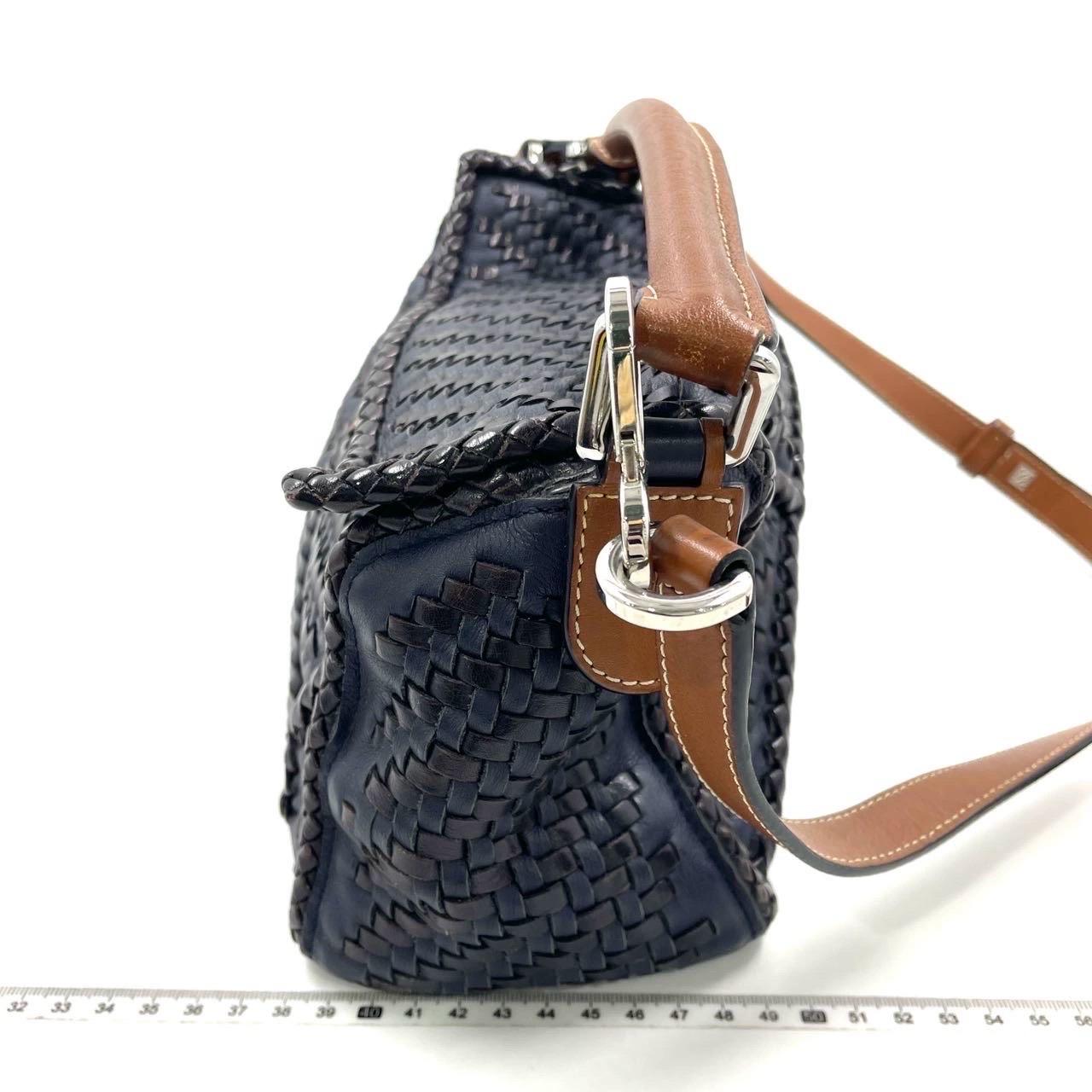 Loewe Puzzle Small Leather Woven Braided Navy Crossbody Bag
 These are professional photos of the actual bag.
 
 Expertly crafted from premium calfskin leather, this crossbody bag is meticulously woven together from strips of the same material. The