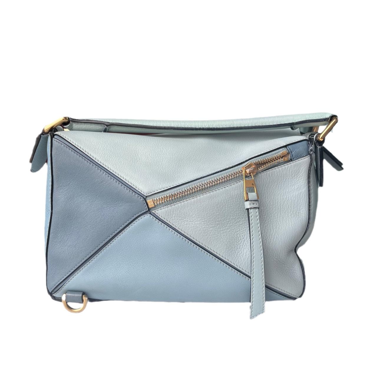 Loewe Puzzle Small Multi tone Blue Leather Crossbody Bag
 These are professional photos of the actual bag offered by Luxbags.
 
 Crafted from supple blue leather and finished with silver hardware and signature origami-inspired panels, this bag is