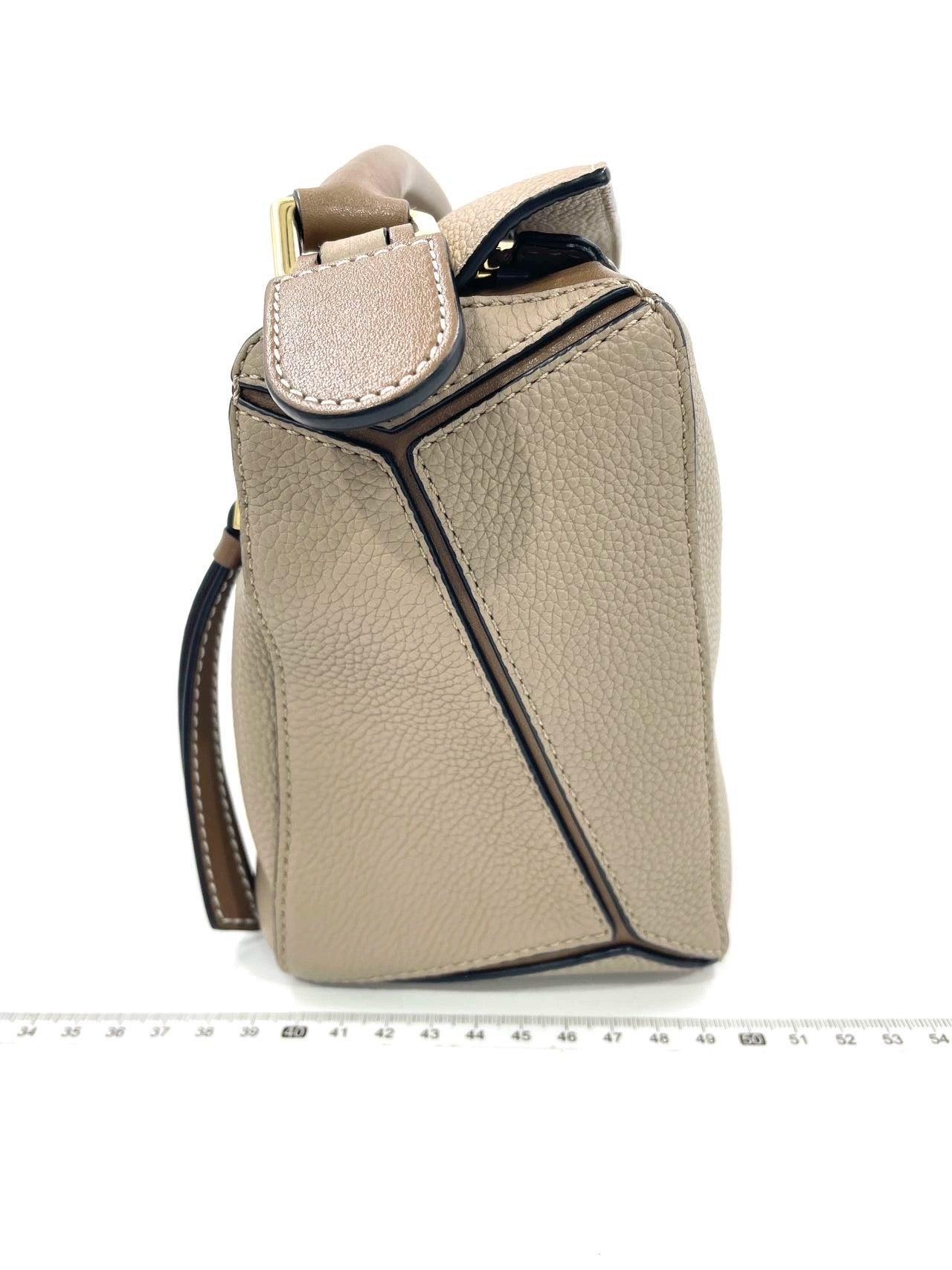 Loewe Puzzle Small Sand Beige Crossbody Bag
 These are professional photos of the actual bag.
 
 CONDITION: MINT
 This preloved item is in excellent condition with no signs of wear. 
 DETAILS:
 
 Calfskin leather
 Sand
 Size Small 
 
 
 Width: 25cm
