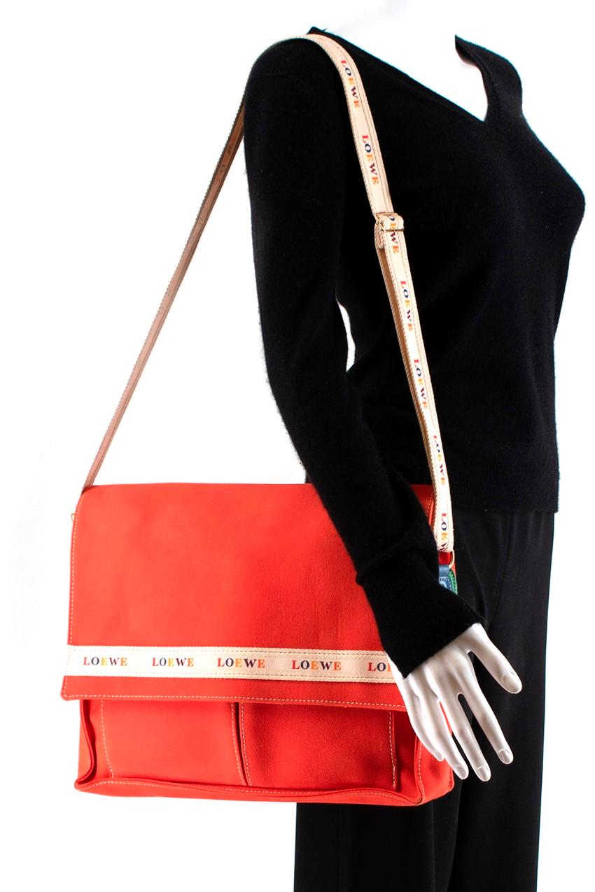 Loewe Red Canvas Vintage Messenger Bag

- Made of soft canvas
- Bright red hue 
- Loewe trim to the front 
- Magnetic fastening to the flap 
- Adjustable branded shoulder strap 
- Leather details 
- 1 inner zipped pocket 
- 2 pockets under the flap