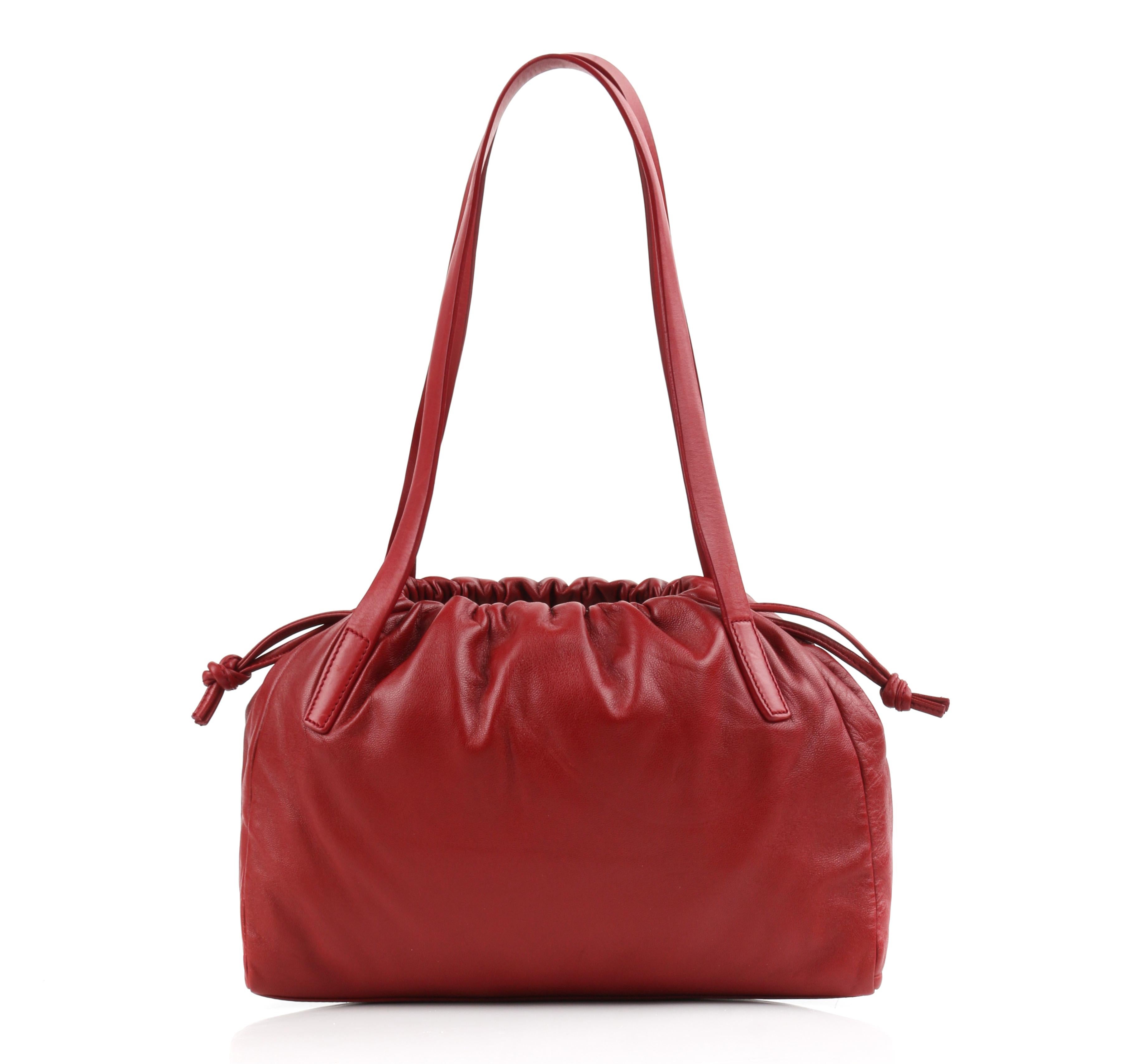 LOEWE Red Napa Leather Drawstring Top Dual Handle Shoulder Hobo Bag
  
Brand / Manufacturer: Loewe
Designer: Jonathan Anderson
Style: Shoulder bag
Color(s): Ruby red (exterior); black (interior)
Lined: Yes
Unmarked Fabric Content: Napa leather