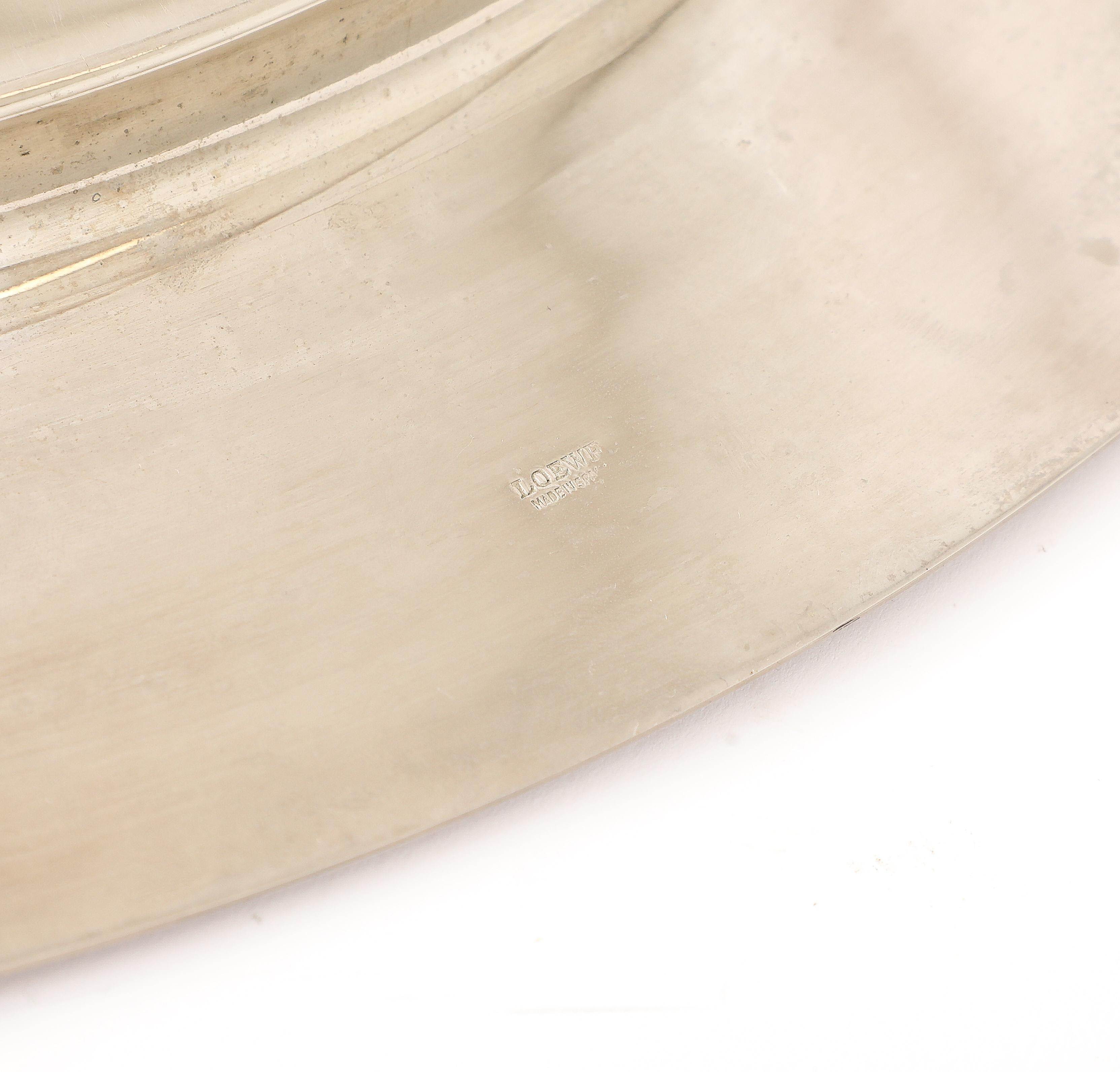 Stainless steel and brass tray with solid brass raised details and the Loewe logo. Stamped underneath.
