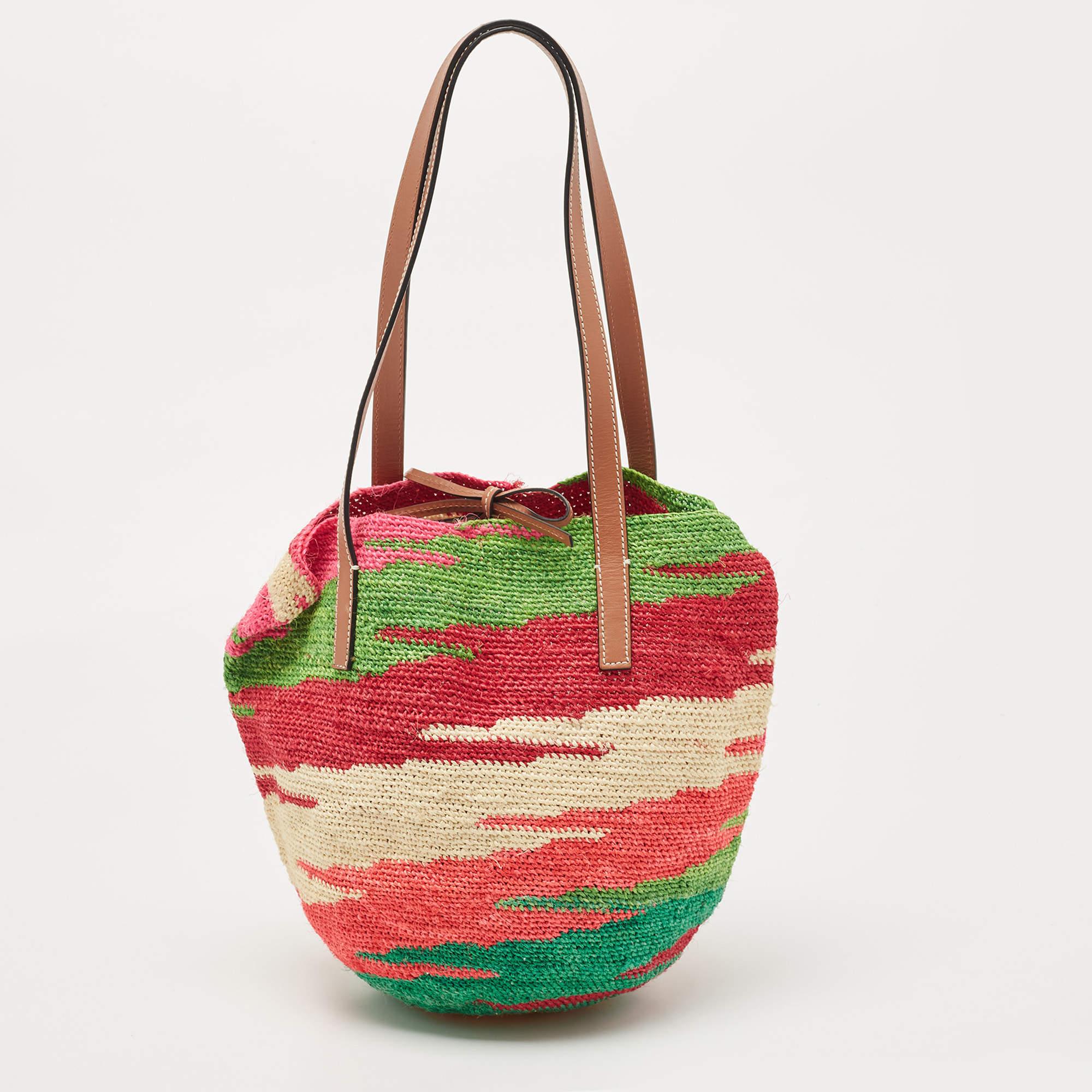 A pretty carryall and one you can carry to brunches with friends or on a lazy day to the park or beach, this LOEWE basket bag will come in handy on many days. It is woven using straw and complemented by leather patches and handles.

Includes: