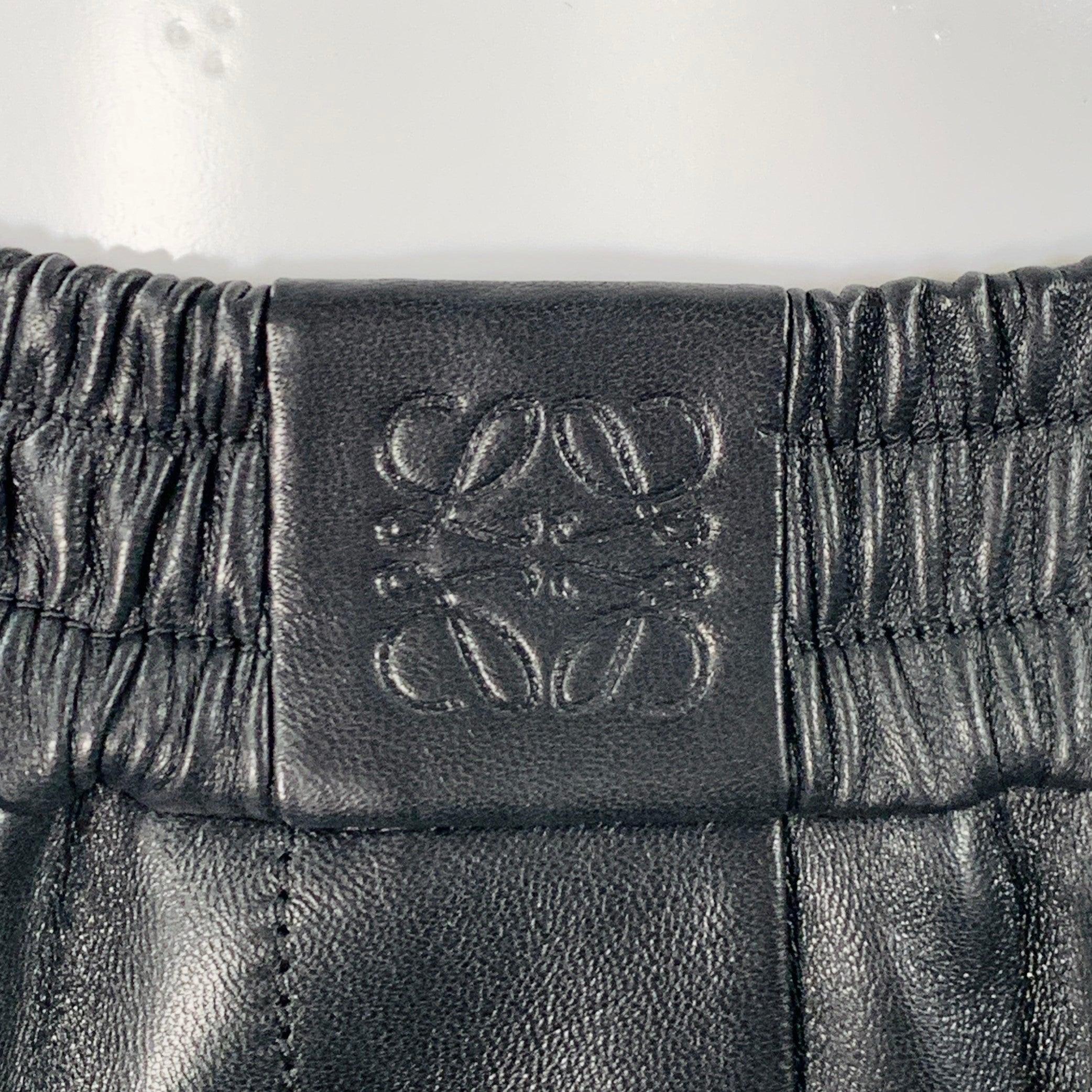 LOEWE cropped dress pants in a black lambskin leather and goat suede featuring a two tone design, wide leg, and elastic waistband. Made in Spainches Excellent Pre-Owned Condition. 

Marked:   XS 

Measurements: 
  Waist: 23 - 28 inches Rise: 11
