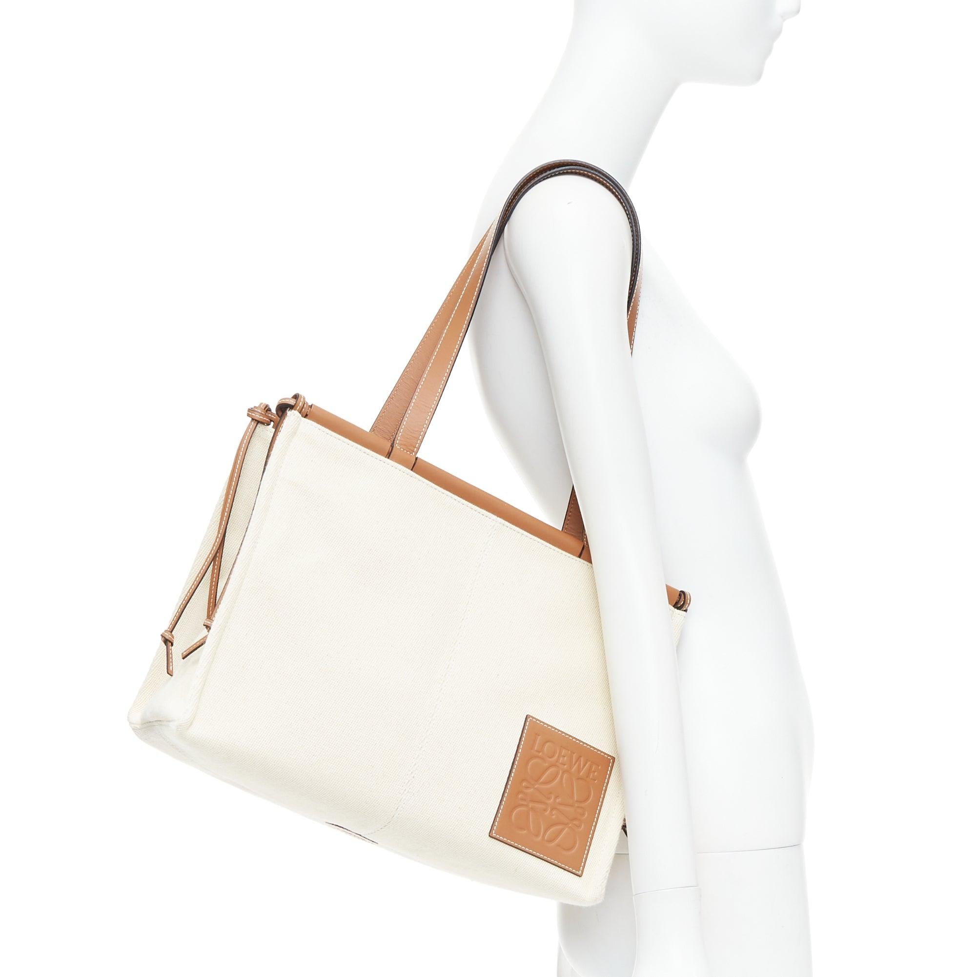 LOEWE Small Cushion cream canvas brown anagram logo shoulder tote bag
Reference: KYCG/A00162
Brand: Loewe
Model: Cushion Small
Material: Canvas, Leather
Color: Brown, Cream
Pattern: Solid
Closure: Self Tie
Lining: Multicolour Fabric
Extra Details: