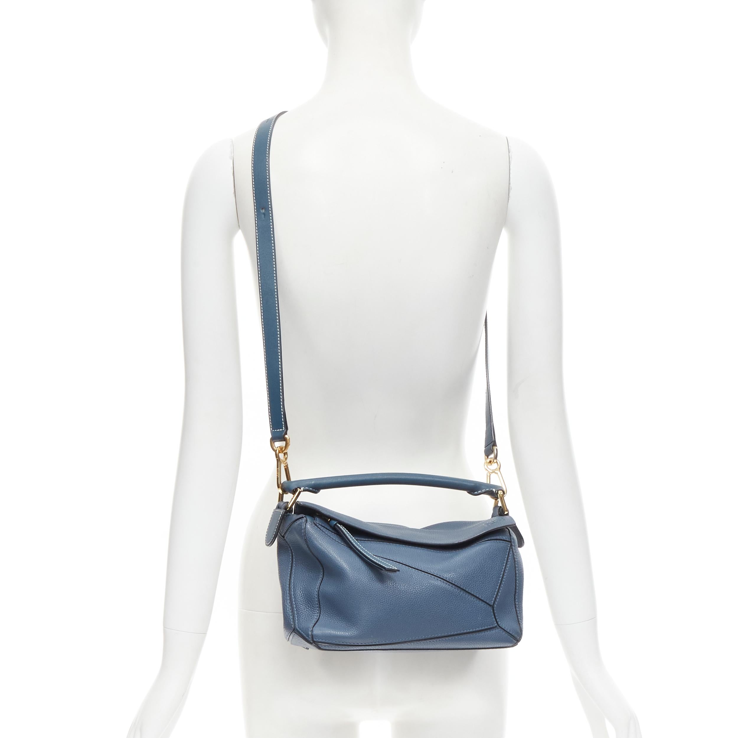 LOEWE Small Puzzle dark blue grained leather gold hardware shoulder bag 
Reference: TGAS/B01615 
Brand: Loewe 
Designer: JW Anderson 
Model: Puzzle Small 
Material: Leather 
Color: Blue 
Pattern: Solid 
Closure: Zip 
Extra Detail: Small Puzzle.