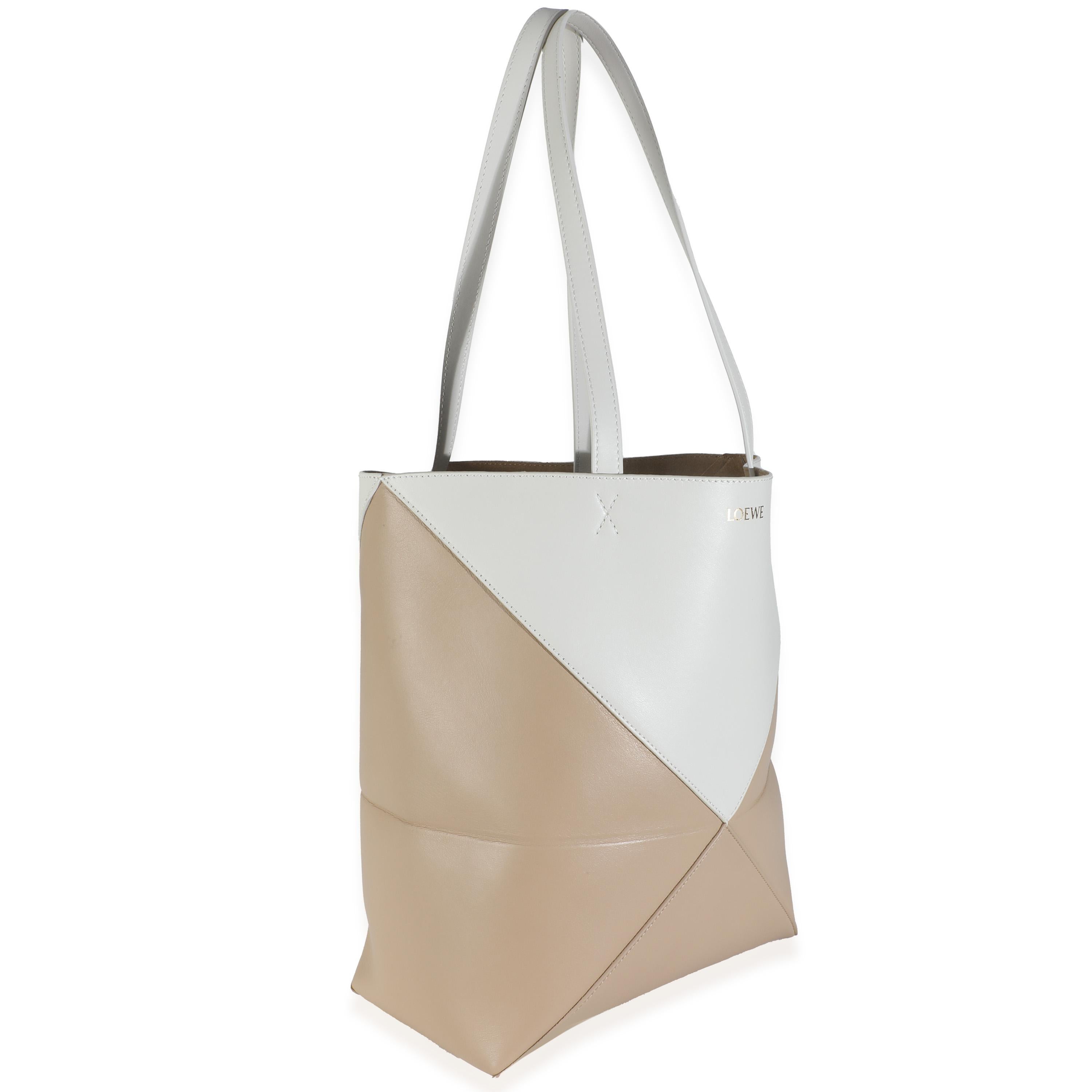 Listing Title: Loewe Soft White Paper Craft Shiny Calfskin Medium Puzzle Fold Tote
SKU: 145797
MSRP: 2400.00 USD
Condition: Pre-owned 
Handbag Condition: Pristine
Condition Comments: Item has no indication of wear.  Final sale.
Brand: Loewe
Model: