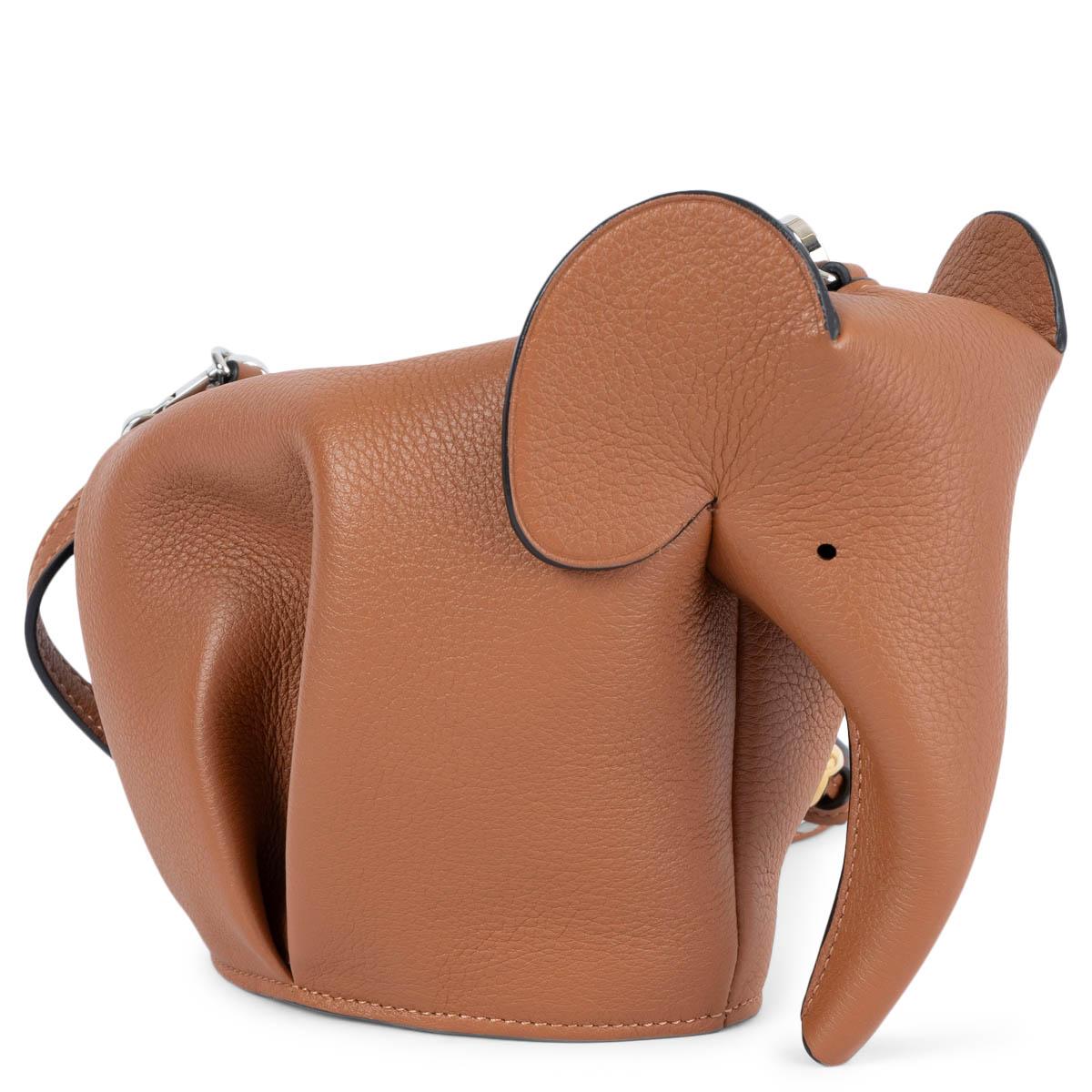 100% authentic Loewe Elephant Mini crossbody bag in tan calfskin. The design features cute gold-tone charm and a tassel on the detachable and adjustable shoulder strap. The bag opens with a zipper on top and is unlined. Has been carried once and is