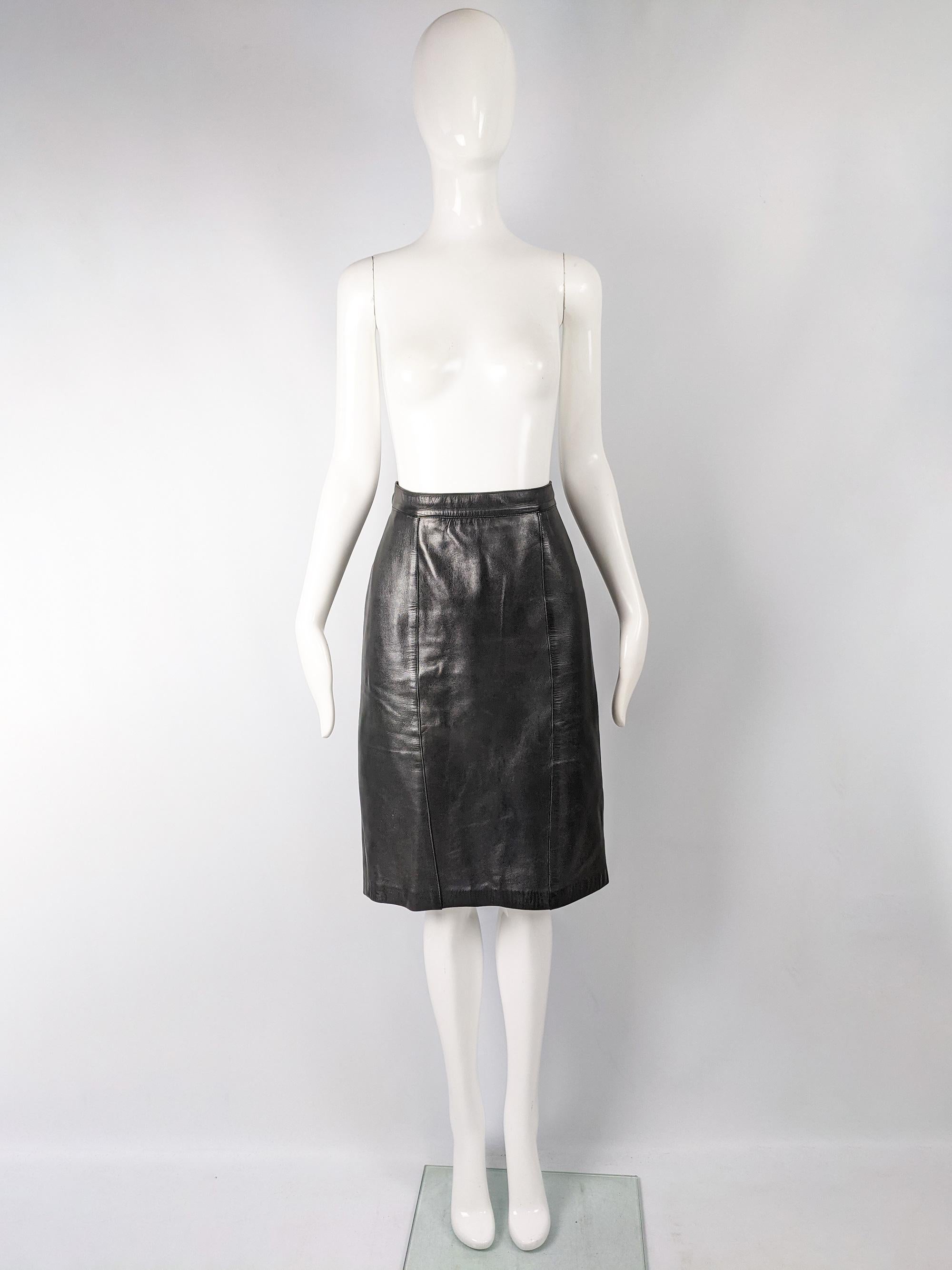 A chic vintage women's skirt from the 80s by a luxury Spanish fashion house, Loewe. In a Buttery soft black leather with a timeless, pencil shape and a button fastening at the back that is engraved with Loewe's logo. 

Size: Marked vintage 44 but