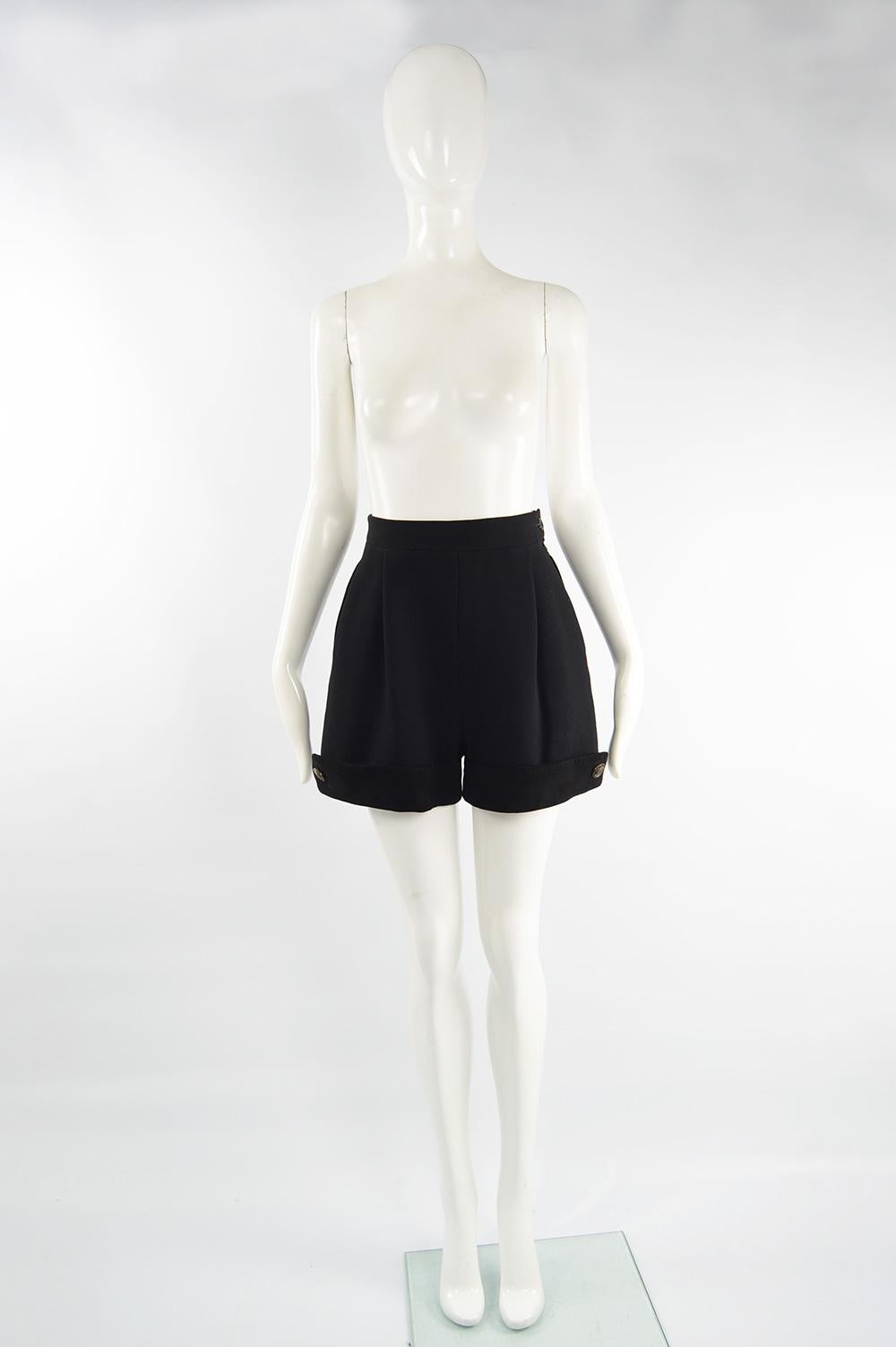 A beautiful pair of vintage Loewe women's shorts from the 80s in a black wool crepe with a wide leg, high waist and black suede turnover. The buttons are engraved with Loewe Madrid 1846 and the lining has the Loewe logo woven in satin