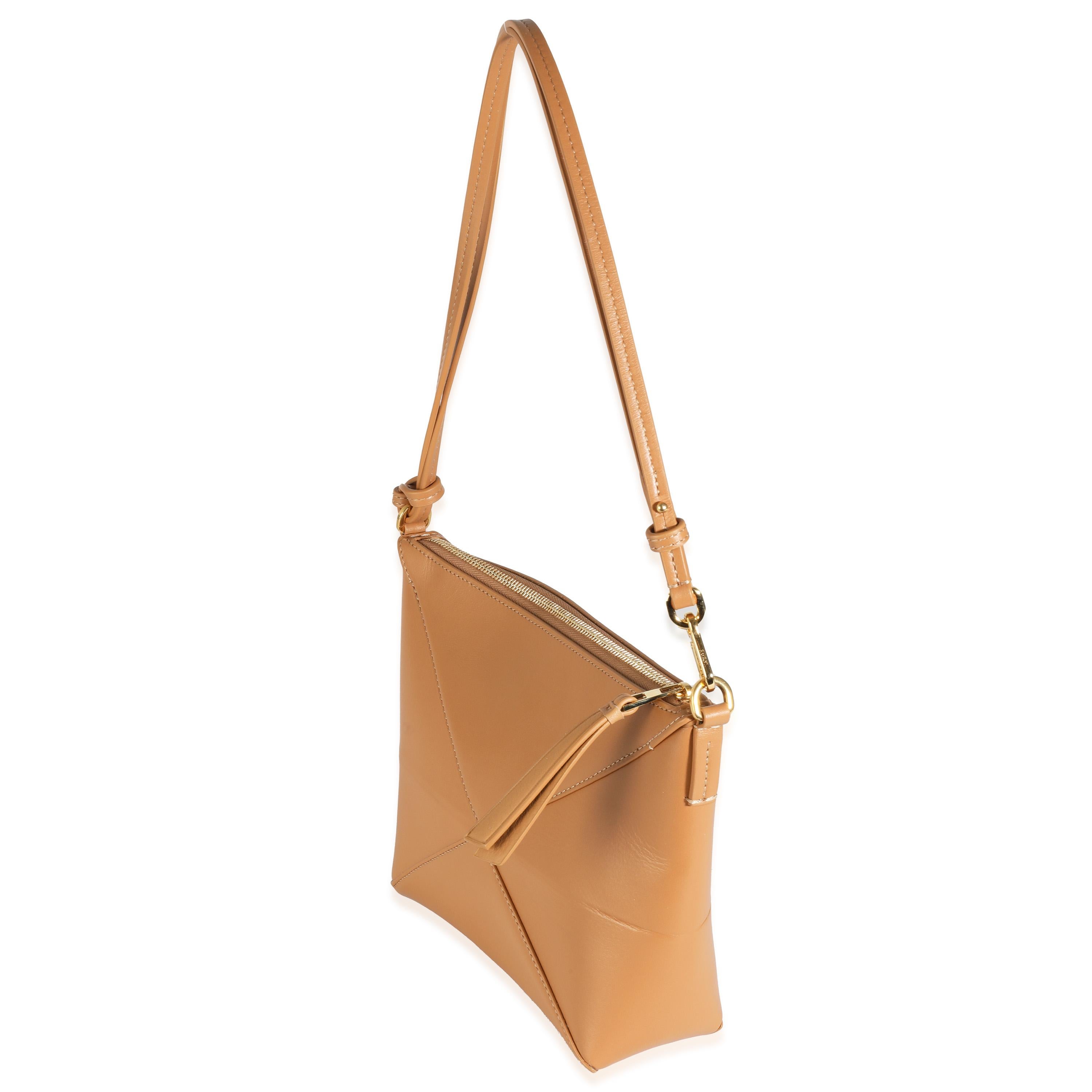 Listing Title: Loewe Warm Dessert Calfskin Puzzle Fold Pouch
SKU: 144281
Condition: Pre-owned 
Handbag Condition: Excellent
Condition Comments: Item is in excellent condition and displays light signs of wear. Light scuffing along corners. Mark along