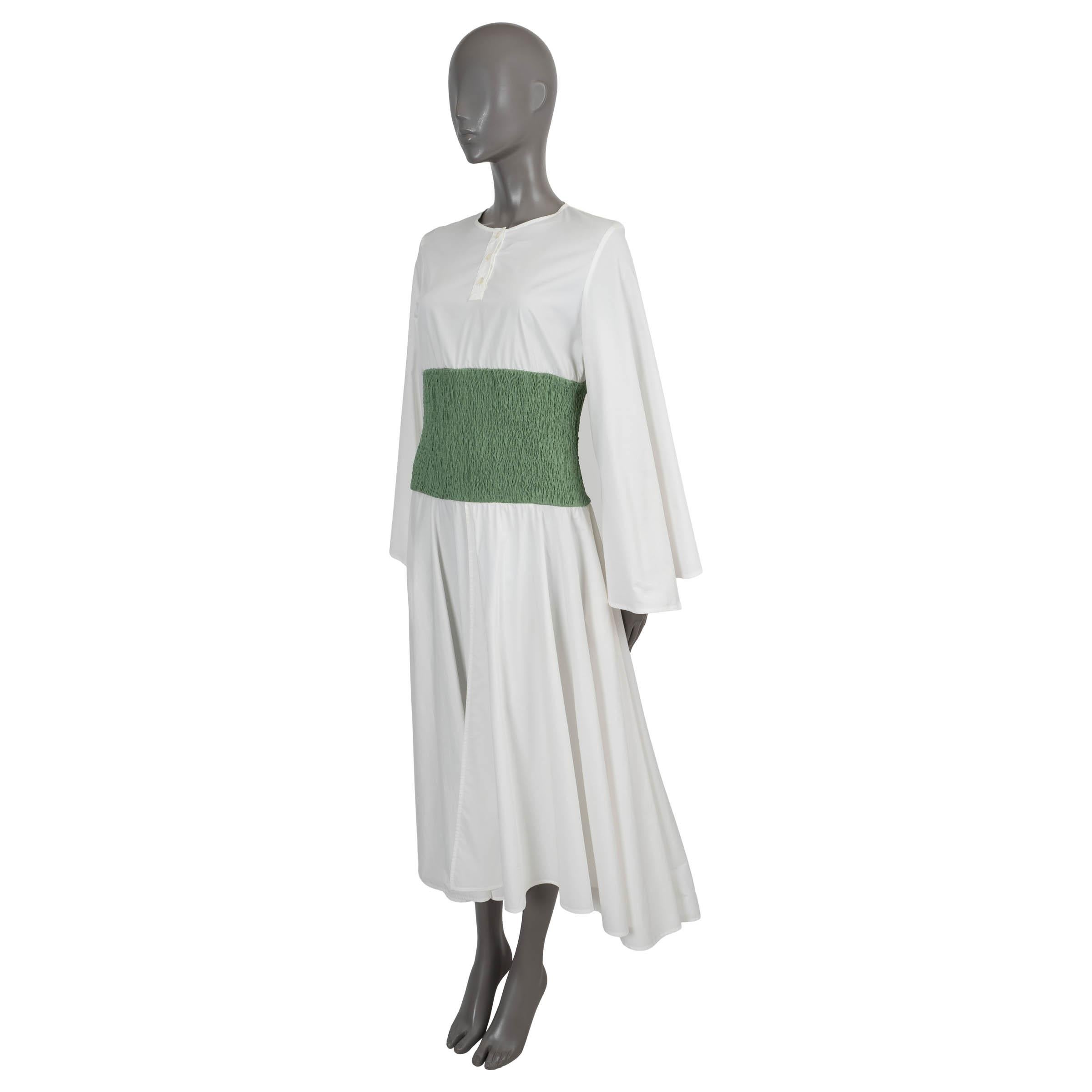 100% authentic Loewe midi dress in white poplin cotton. Features a round neck with buttons, wide sleeves, a smocked waist in pistachio green and a flares skirt that's slightly longer in the back. Opens with a zipper on the side. Unlined. Has been