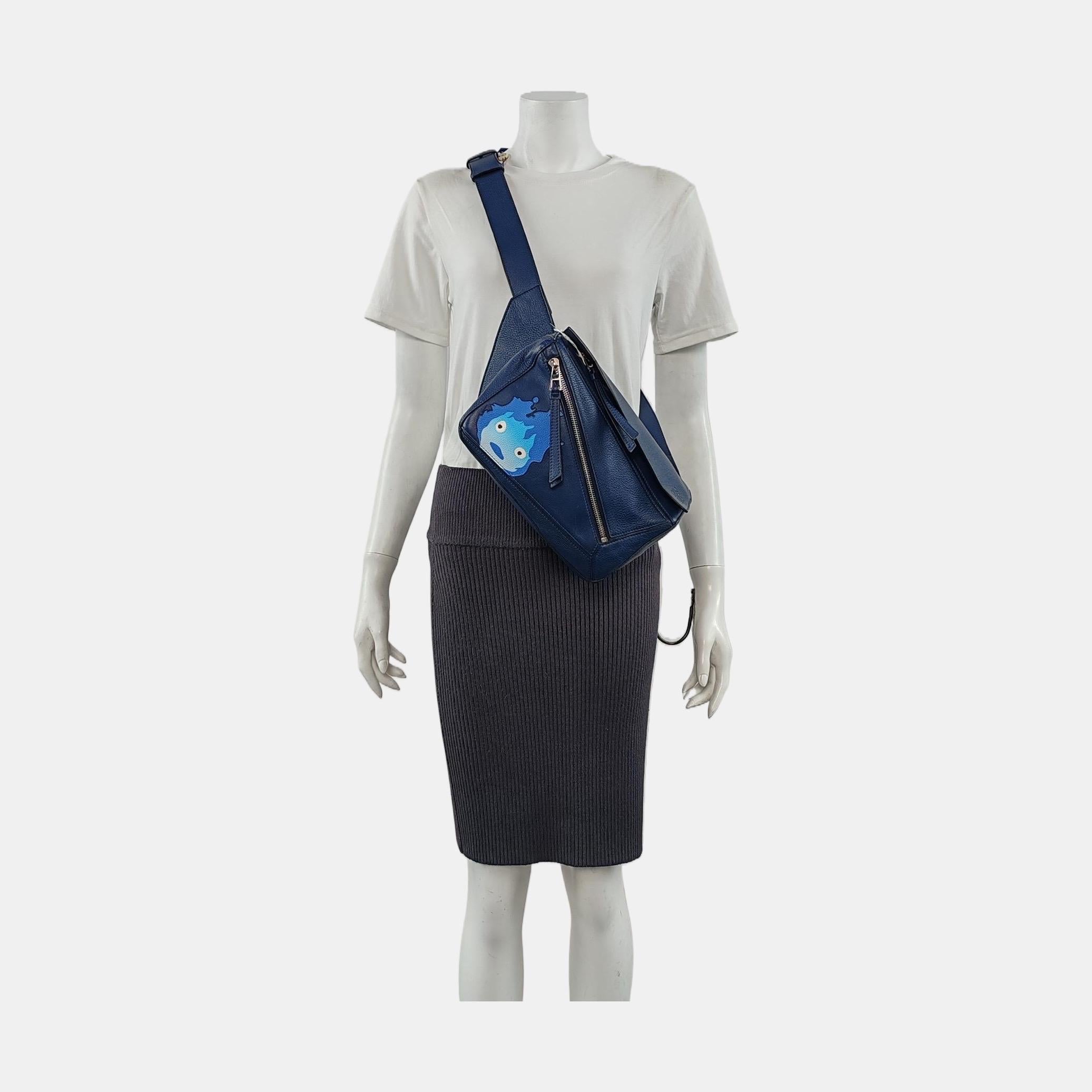 This is from the sell-out collaboration between Loewe and the Japanese anime studio Studio Ghibli. This particular mini puzzle bag features a character from the anime Howl's Moving Castle. 

CONDITION: EXCELLENT

light stains scratches and creases.