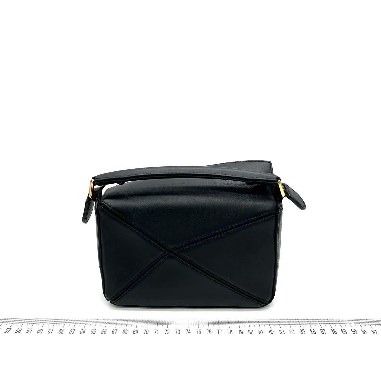 Loewe x Howl's Moving Castle Studio Ghibli Collection Puzzle Calcifer Mini Black Crossbody Bag
  These are professional photos of the actual bag offered by Luxbags.
  
  This is from the sell-out collaboration between Loewe and the Japanese anime