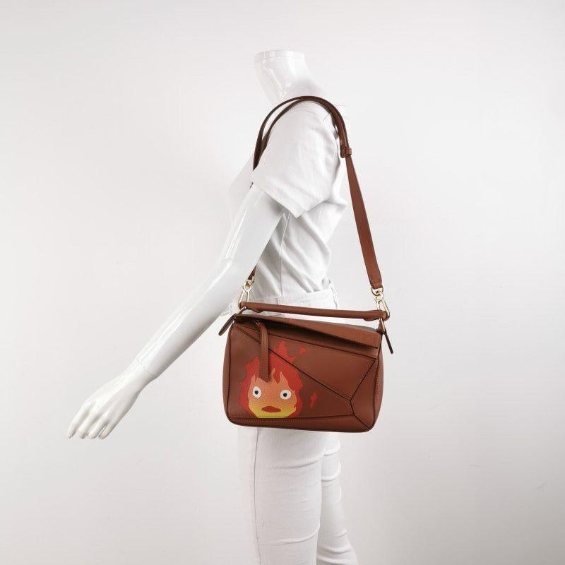 Loewe x Howl's Moving Castle Studio Ghibli Collection Puzzle Calcifer Small Tan Caramel
 These are professional photos of the actual bag.
 
 This is from the sell-out collaboration between Loewe and the Japanese anime studio Studio Ghibli. This