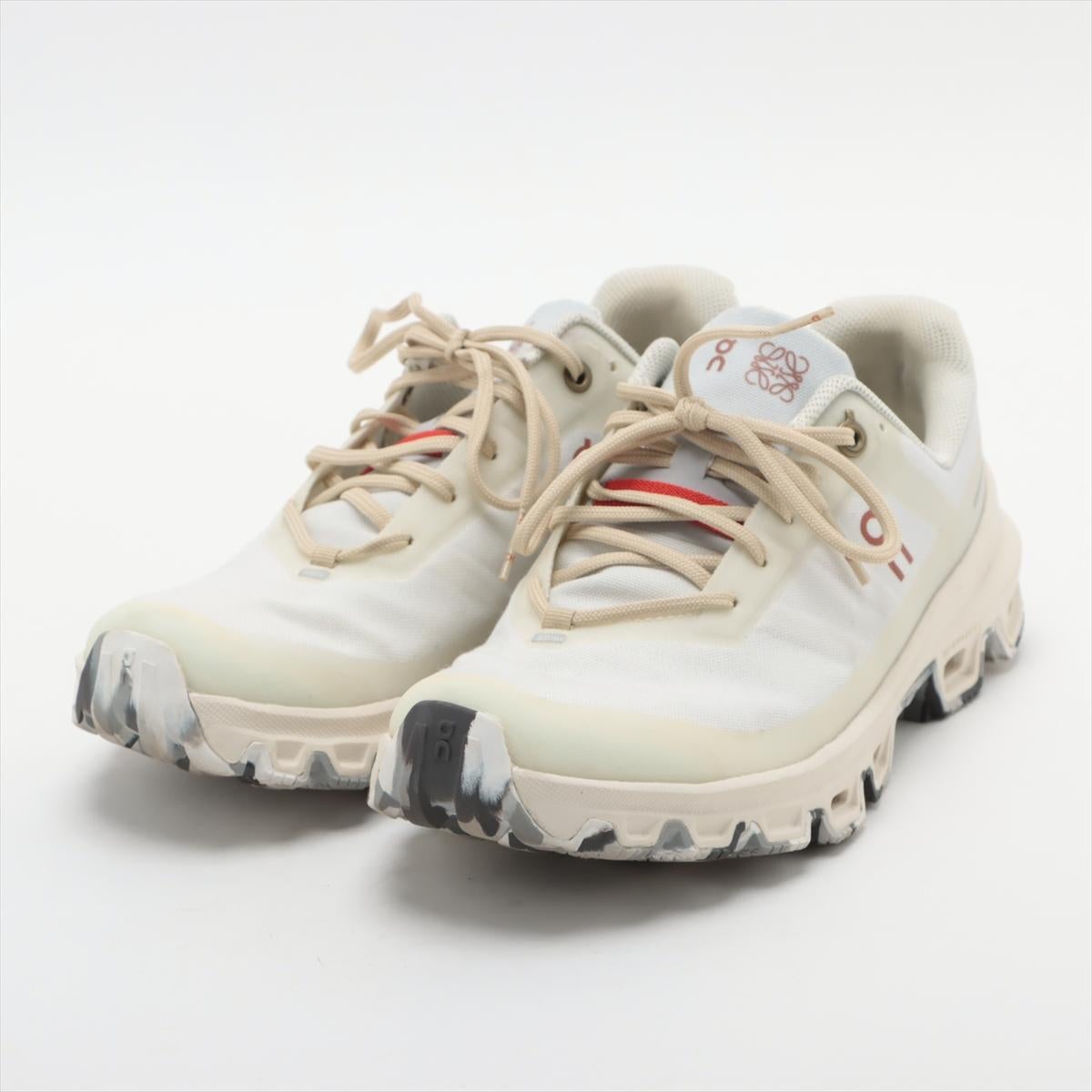 The Loewe x On Cloud Ventures Sneaker in Black and Gray is a sleek and contemporary footwear choice with a touch of urban edge.  The sneakers feature a clean white upper with subtle beige shoe lace, creating a minimalist yet sophisticated aesthetic.