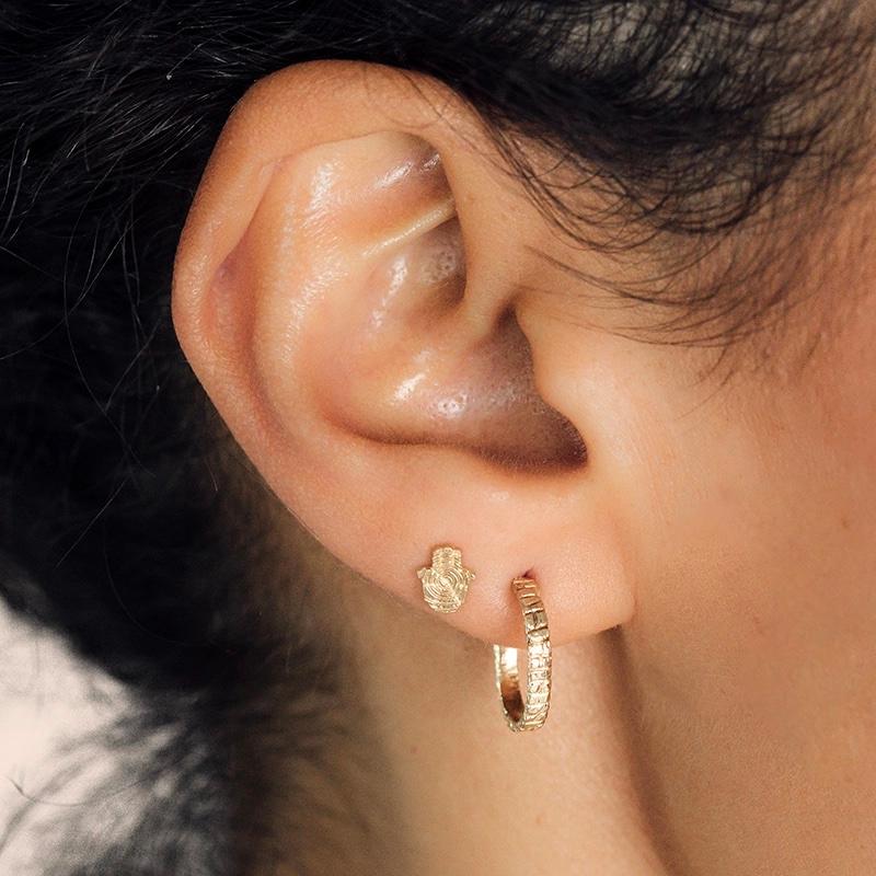 The Hamsa Hand is a symbol of protection and good fortune, making these intricate studs the perfect gift for someone special.

Beautifully crafted in 14-karat gold, they integrate the intricate details of a log, creating a harmonious piece that