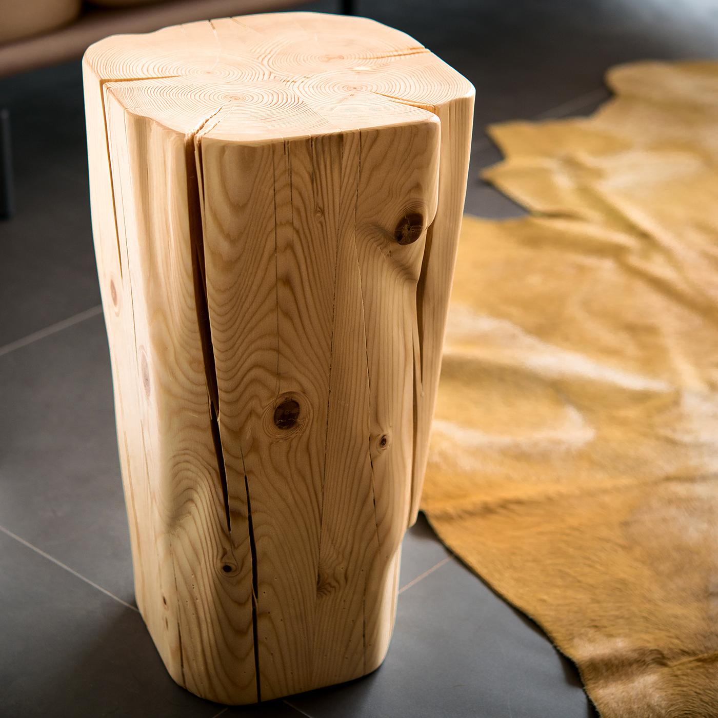 Showcasing the exquisite natural wood grain, this stool is a unique piece of functional decor suitable for rustic-modern interiors. Reduced to rigorous geometric lines, the slightly tapered shape is carved entirely by hand exalting the intrinsic