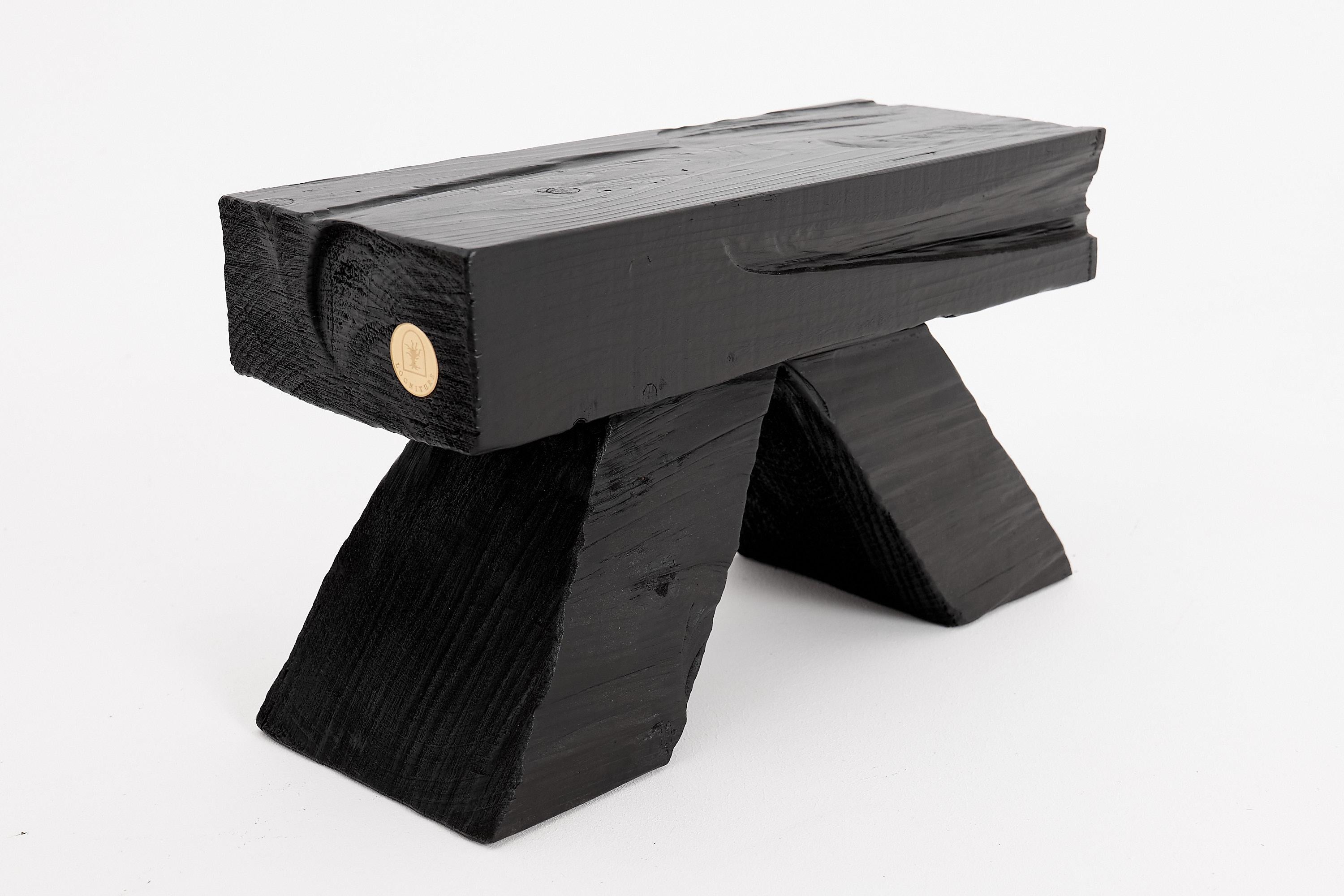 Carved Logniture, Blackened Wood Stool with Angled Geometric Base – Bold Artisan Design For Sale