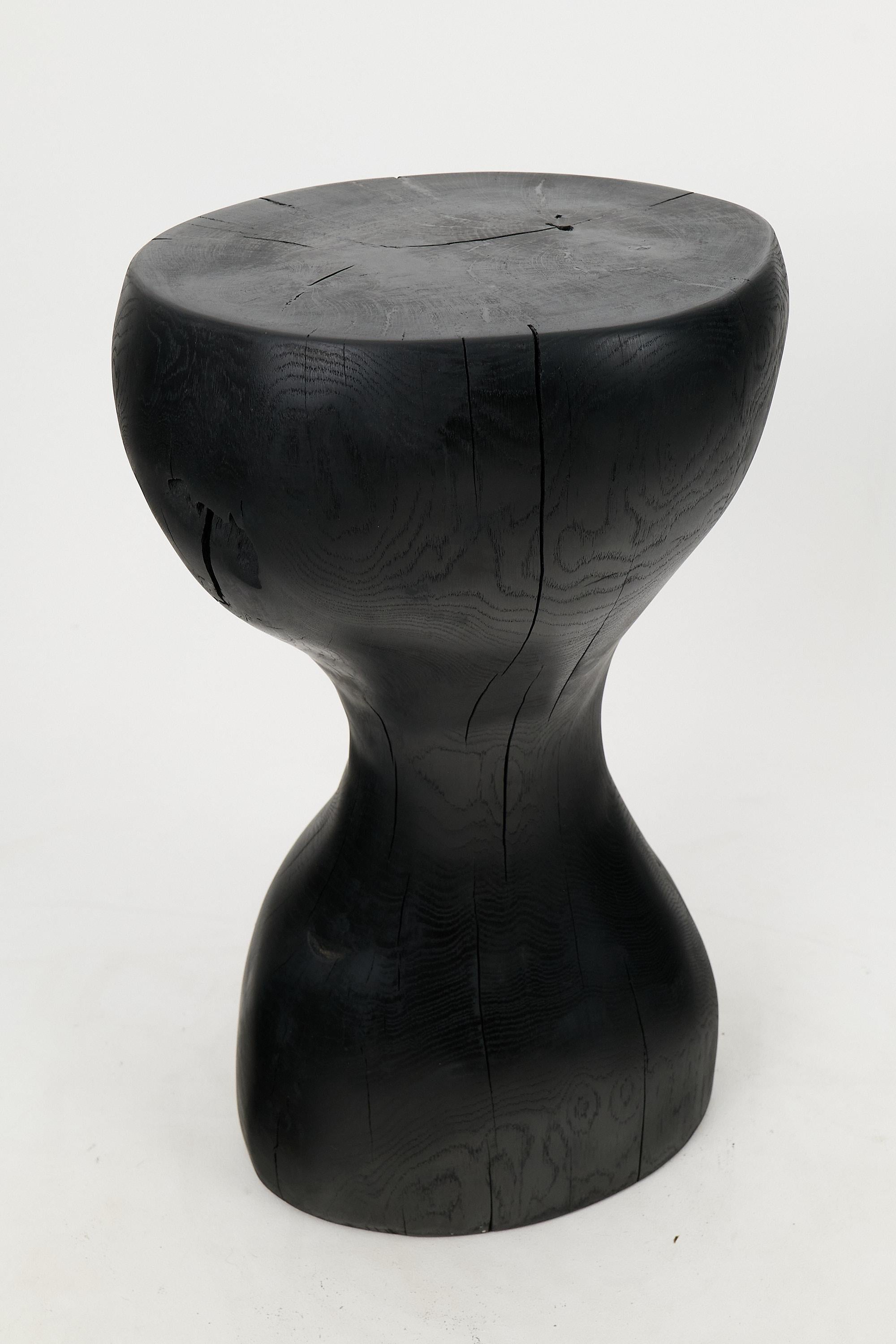Chainsaw carved side table. Carved from a single piece of burnt wood and protected with the highest quality oils, ensuring durability for generations. Such unique handmade design will highlight your interior and bring comfort to your home, which