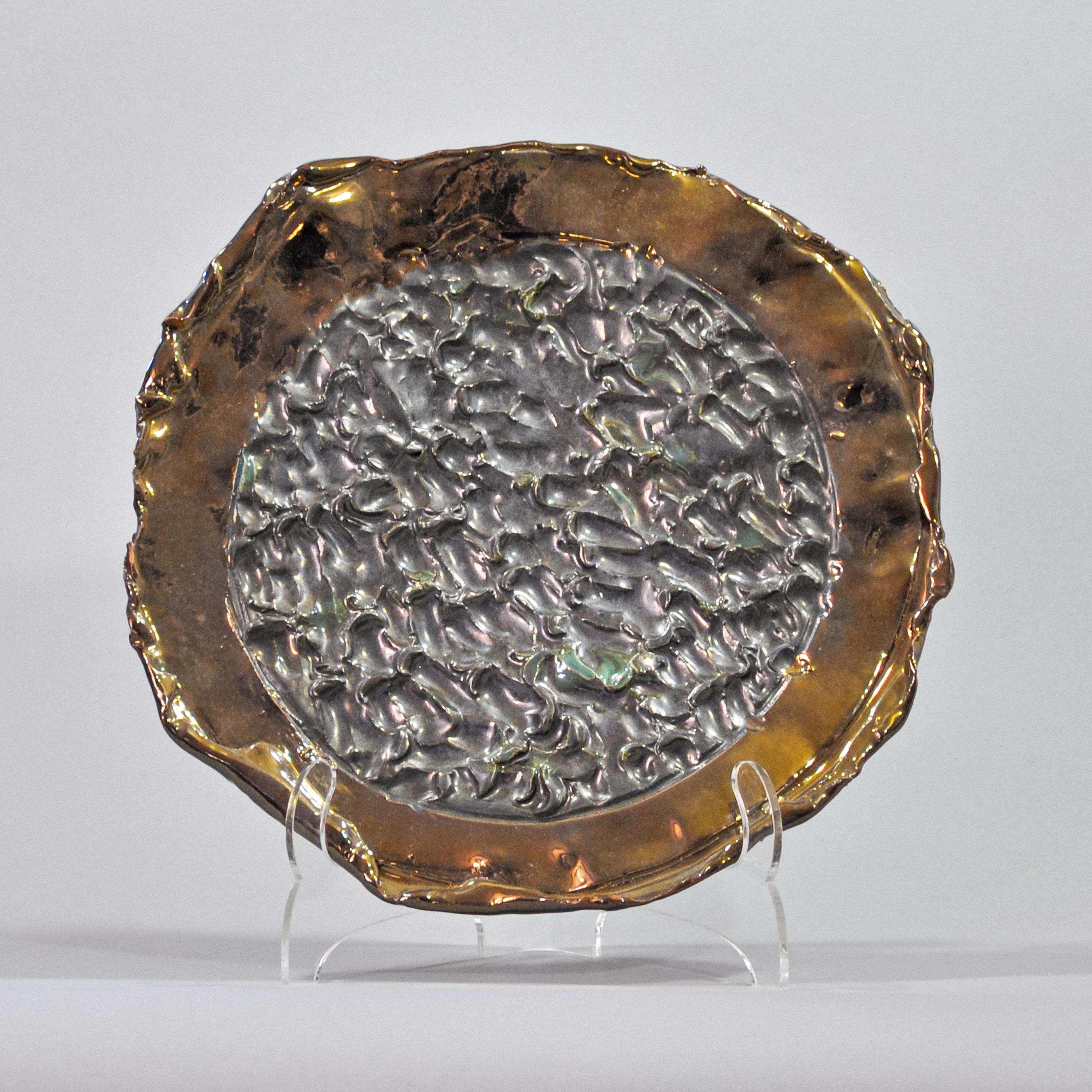 Artist Commentary:
Bronze Platter with metallic pewter center. Medium: ceramic porcelain. Size: 13 inch diameter and 2 inches deep (33 cm diameter and 5 cm deep). Made in California, USA.

Artwork Details:
Bronze Platter with metallic pewter center.