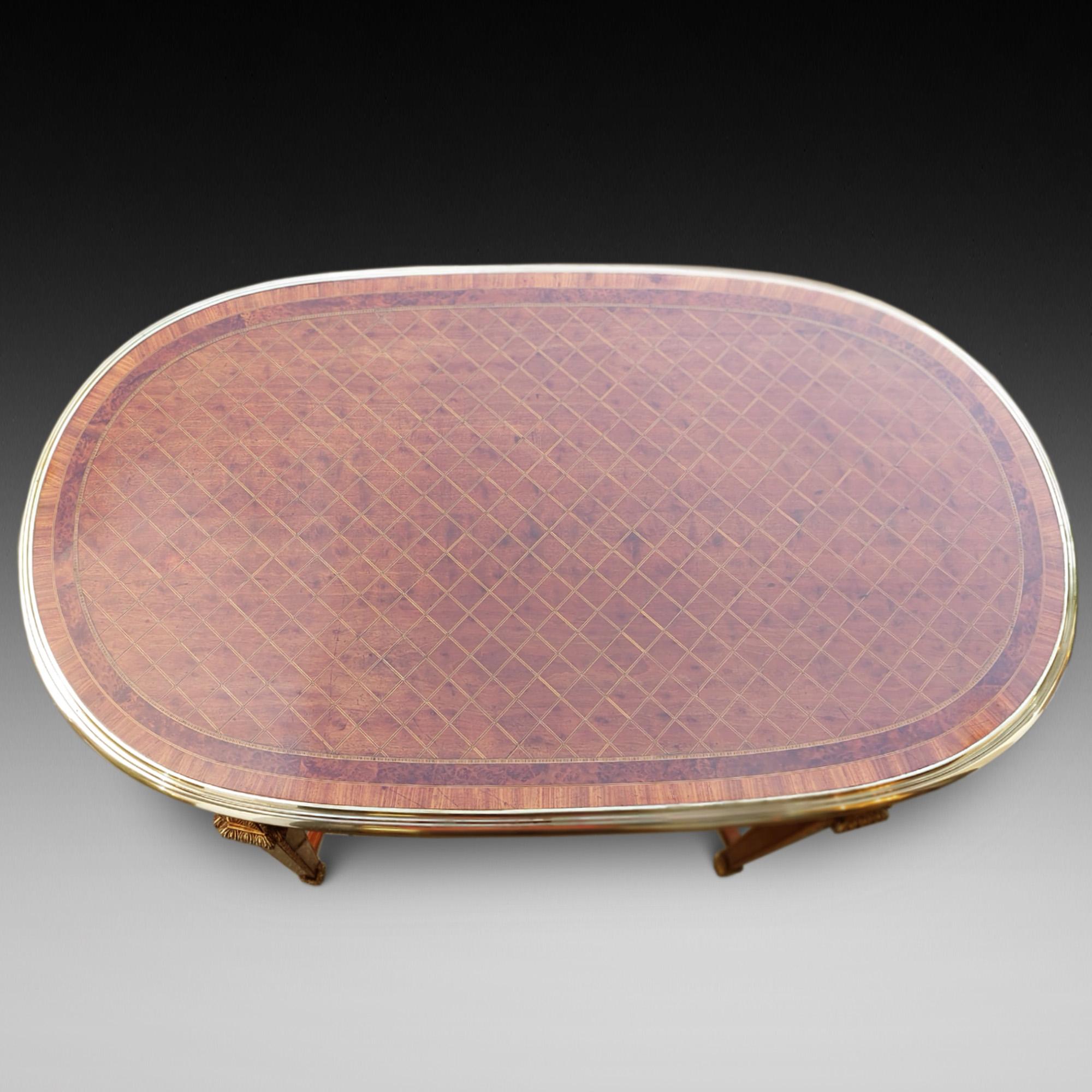 Loius XVI Style Inlaid Centre Table the brass banded top with amboyna and rosewood crossbanding and diamond inlay, curved X-Stretcher and the base decorated with ormalu - English c1860 - 47