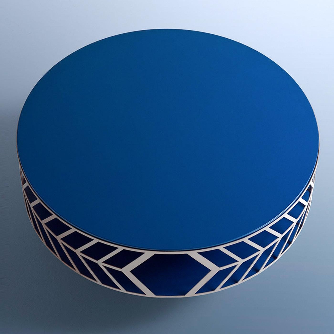 This sculptural coffee table was designed to be the focal point in a dull modern living room. Its MDF frame, lacquered in an intense shade of matte blue, is comprised of a structural column and two disks sealing the wide storage compartment that is