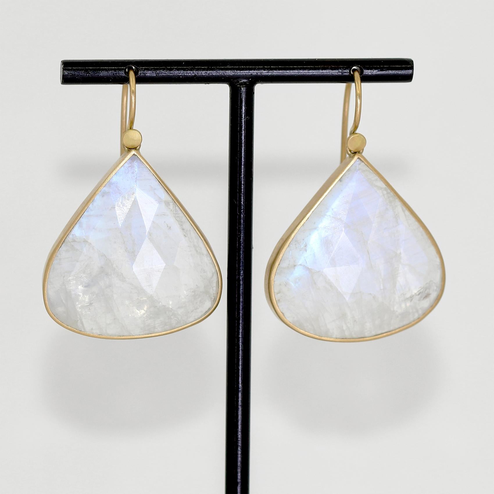 One of a kind earrings hand-fabricated by acclaimed jewelry maker Lola Brooks in the artist's signature-finished 18k yellow gold showcasing a perfectly matched pair of faceted blue moonstone teardrops totaling 36.85 carats, and finished on Lola's