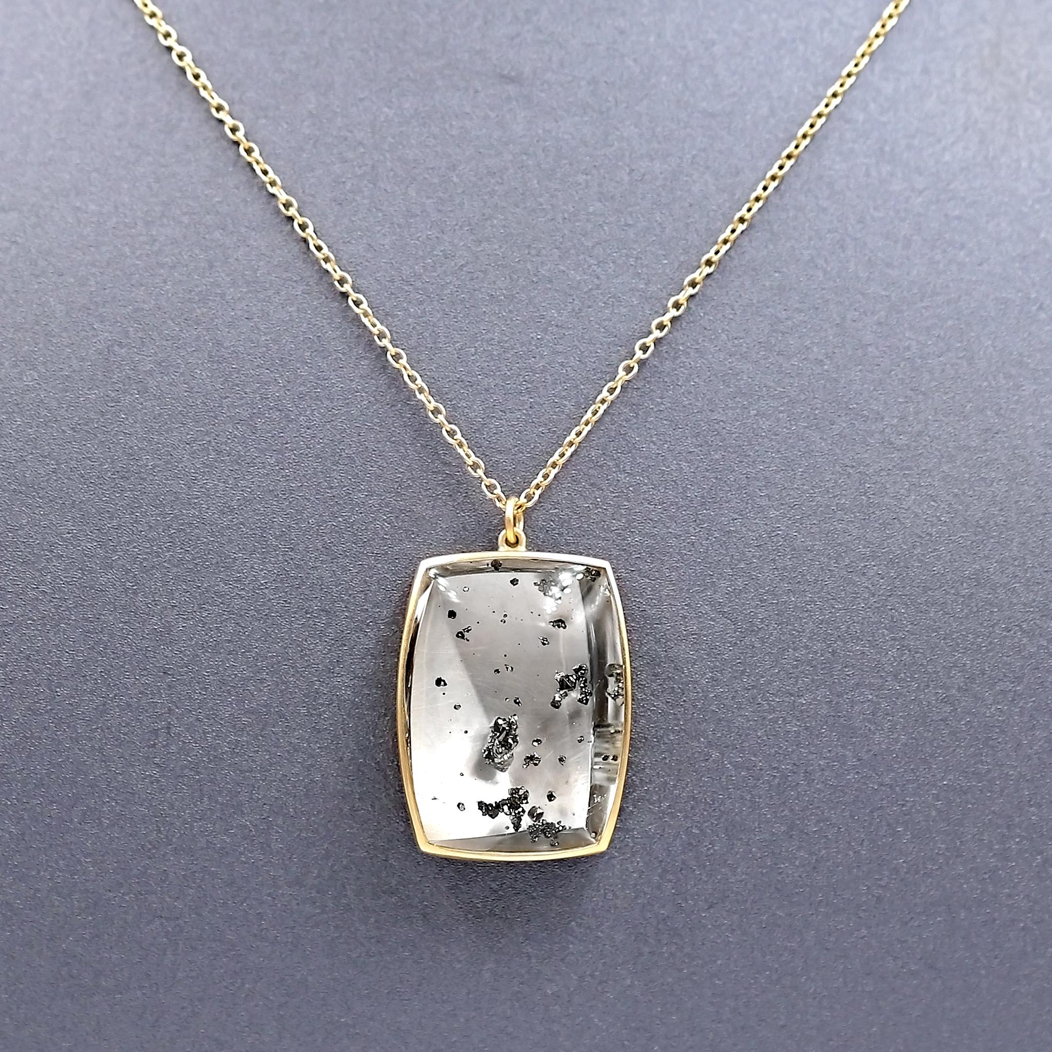 One of a Kind Necklace hand-fabricated by jewelry maker Lola Brooks featuring a remarkable, unusual 45.67 carat quartz cabochon that showcases a vibrant, three dimensional array of shimmering natural pyrite crystals. The phenomenal gem is bezel-set