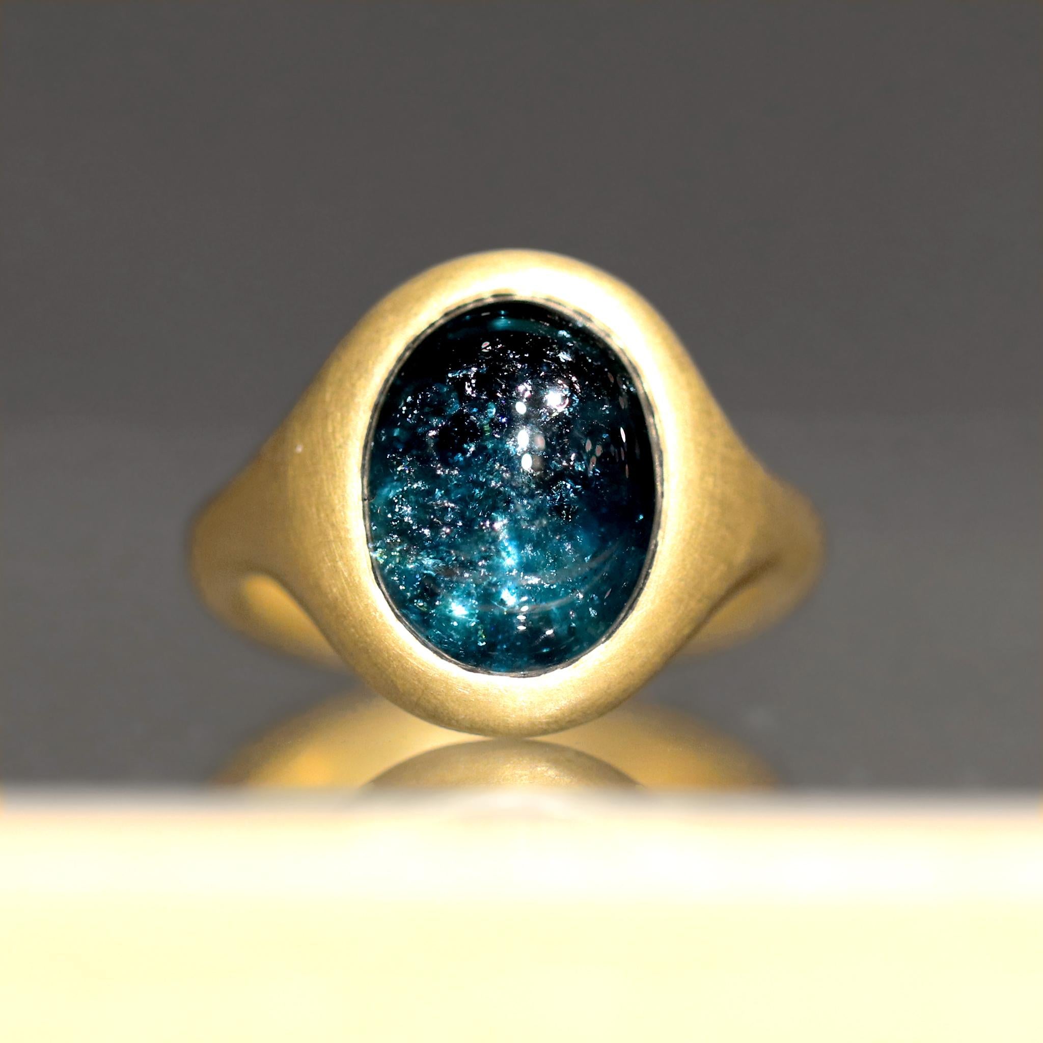 One of a Kind Ring hand-fabricated by jewelry maker Lola Brooks showcasing an absolutely spectacular, glowing 5.32 carat deep blue indicolite tourmaline oval cabochon that features a galaxy within, bezel-set in the artist's signature cast and