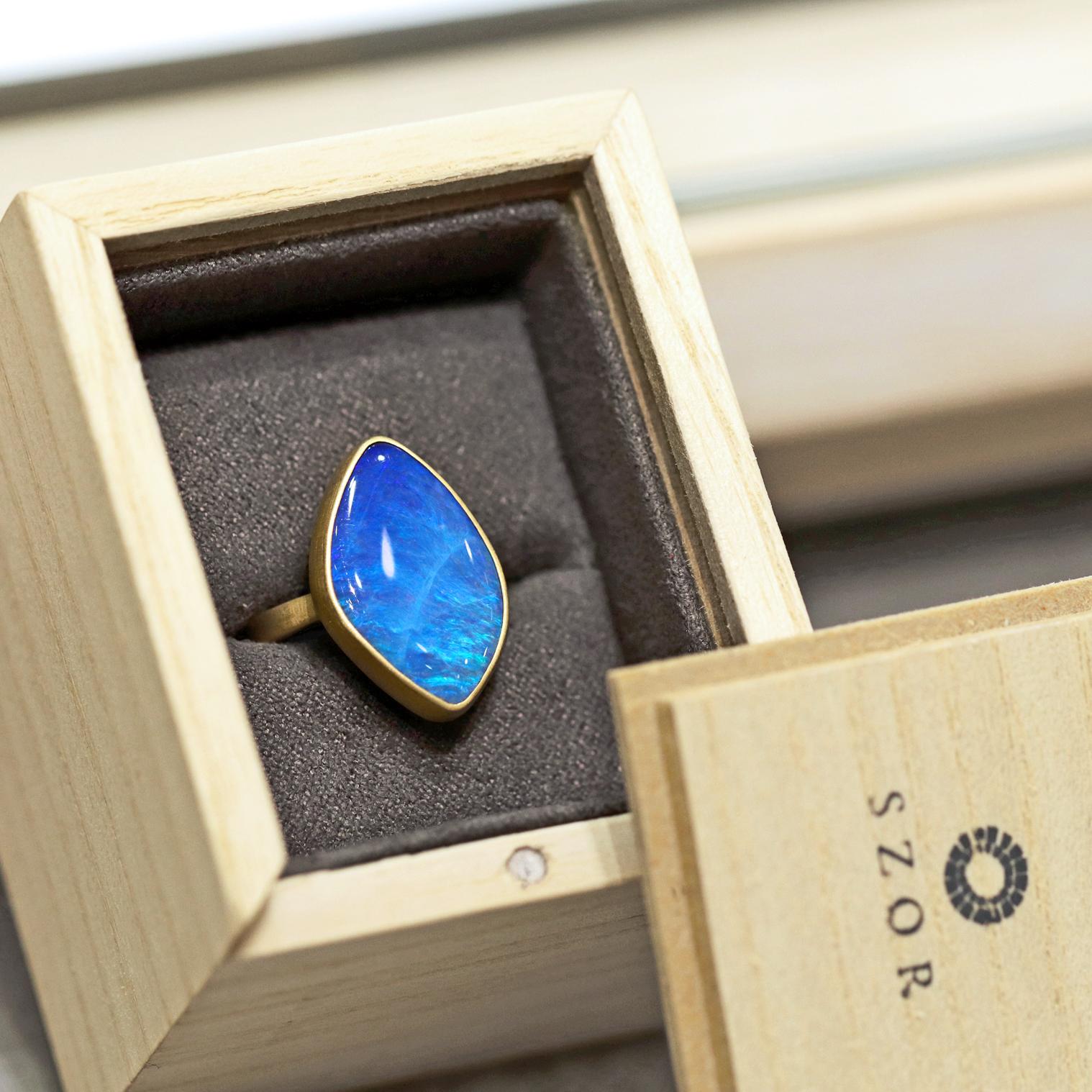 One of a Kind Ring hand-fabricated by jewelry maker Lola Brooks showcasing a spectacular, irregular diamond-shaped, brilliant blue Australian boulder opal with beautiful neon blue and neon green flash. The remarkable gem is bezel-set and framed in