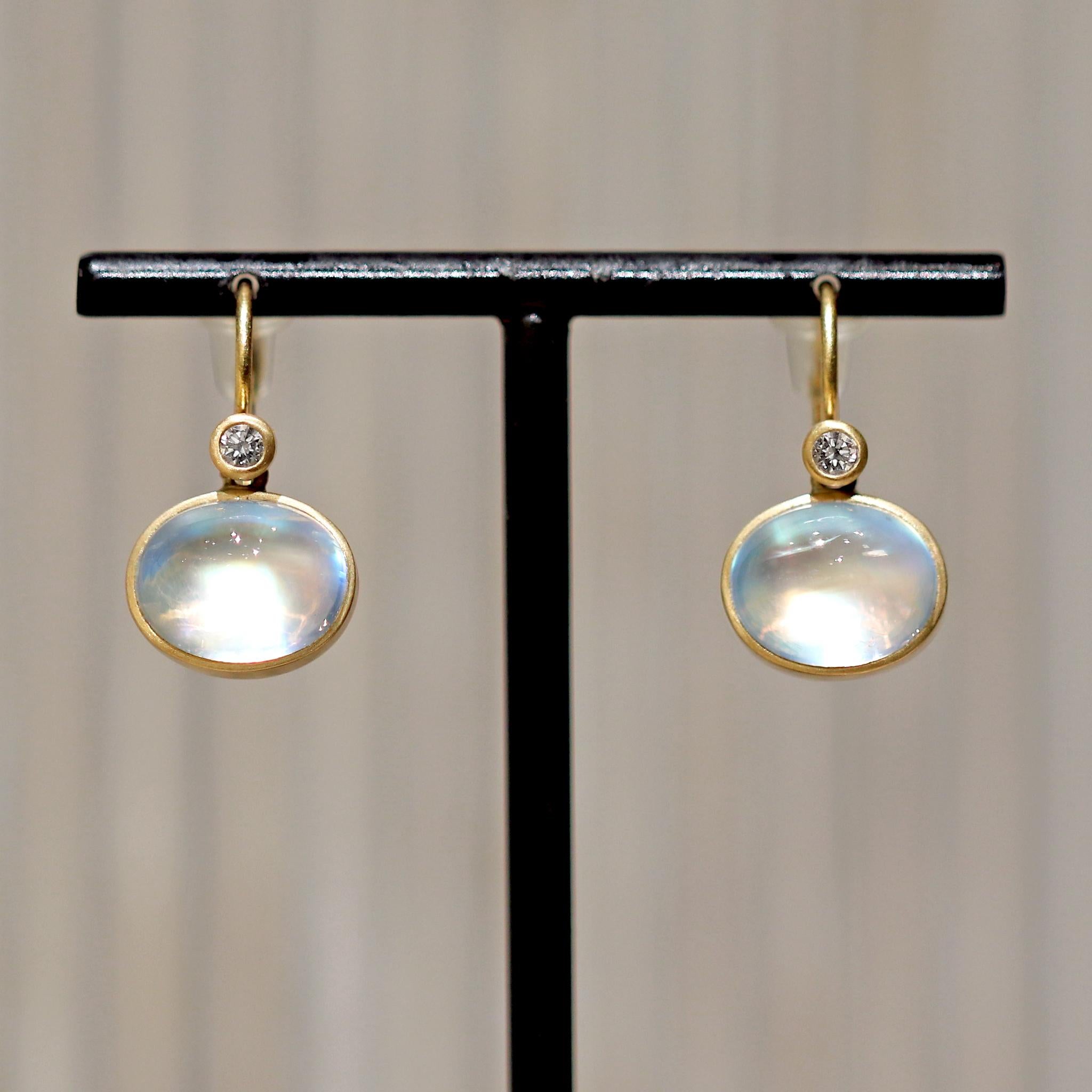 One of a Kind Double Gem Earrings by jewelry maker Lola Brooks hand-fabricated in 18k yellow gold featuring a spectacular matched pair of translucent rainbow moonstone oval cabochons totaling 6.89 carats, bezel-set and complemented by 0.01 carat