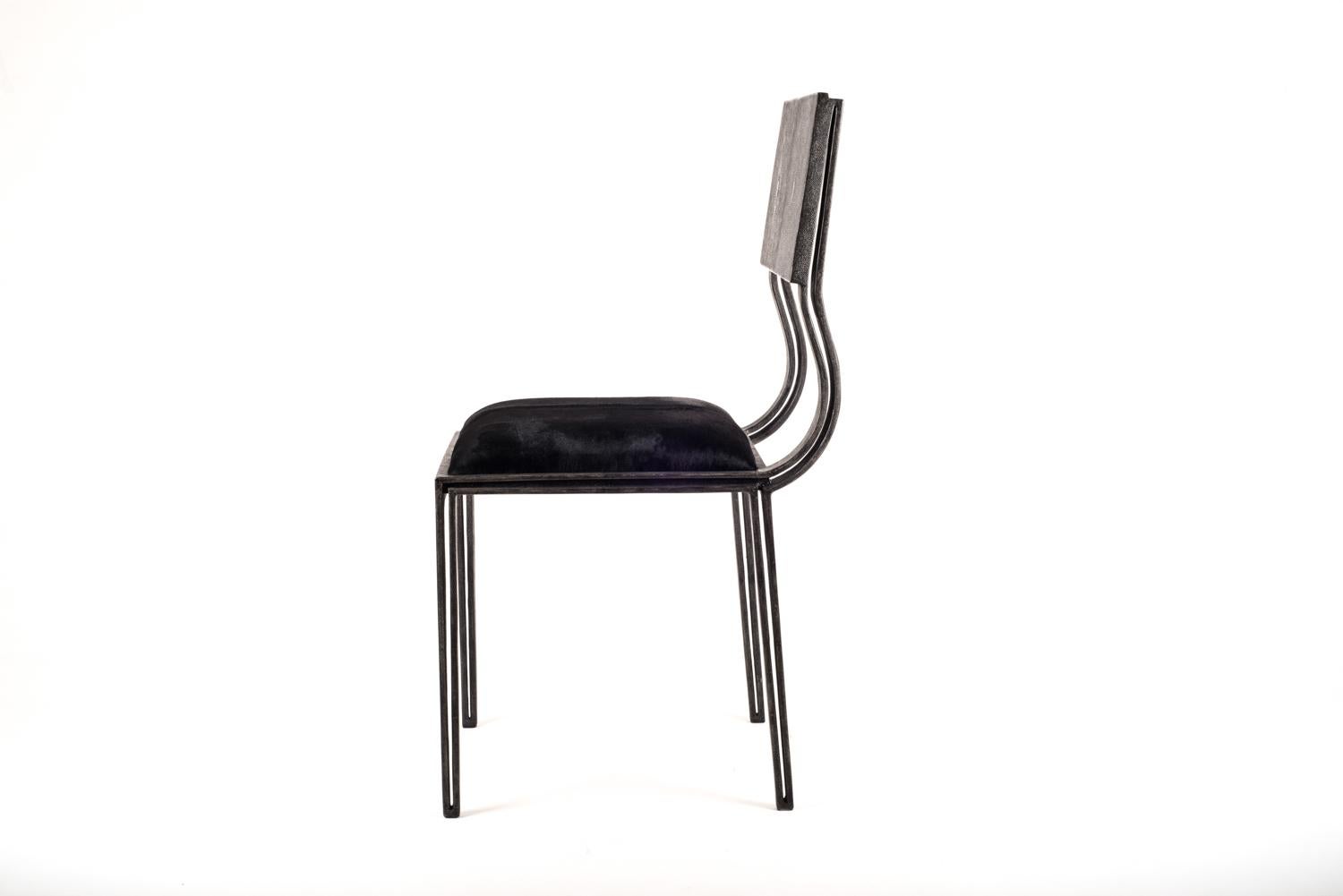 The Lola chair mixes elegance and comfort. Perfect for your dining room. The coal black shagreen legs are unique and subtle with it's indentation details that complement the overall piece. The seat is upholstered in a luxurious soft horsehair.