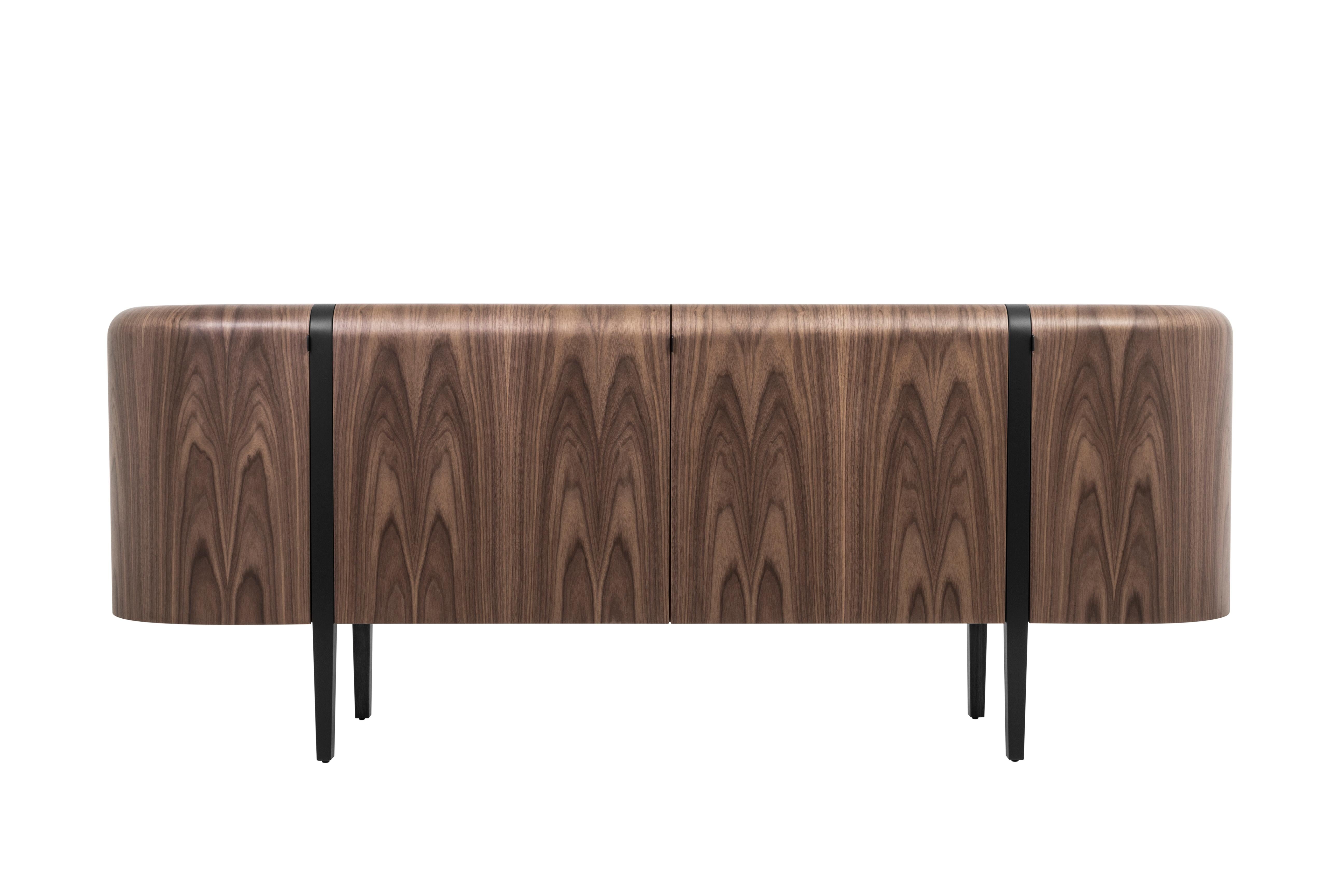 Crafted from American walnut veneer with a natural finish, the Lola sideboard is a harmonious element that seamlessly blends contemporary design with modernism. The round purity of this sideboard creates a visual effect that is both stunning and