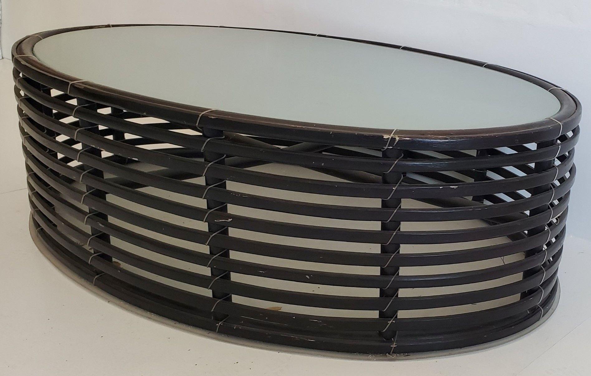 Lolah Kenneth Wood Large Wood And Glass Coffee Table

Smoked Glass 1/4 inch thick
Black Painted wood
PVC type bas.