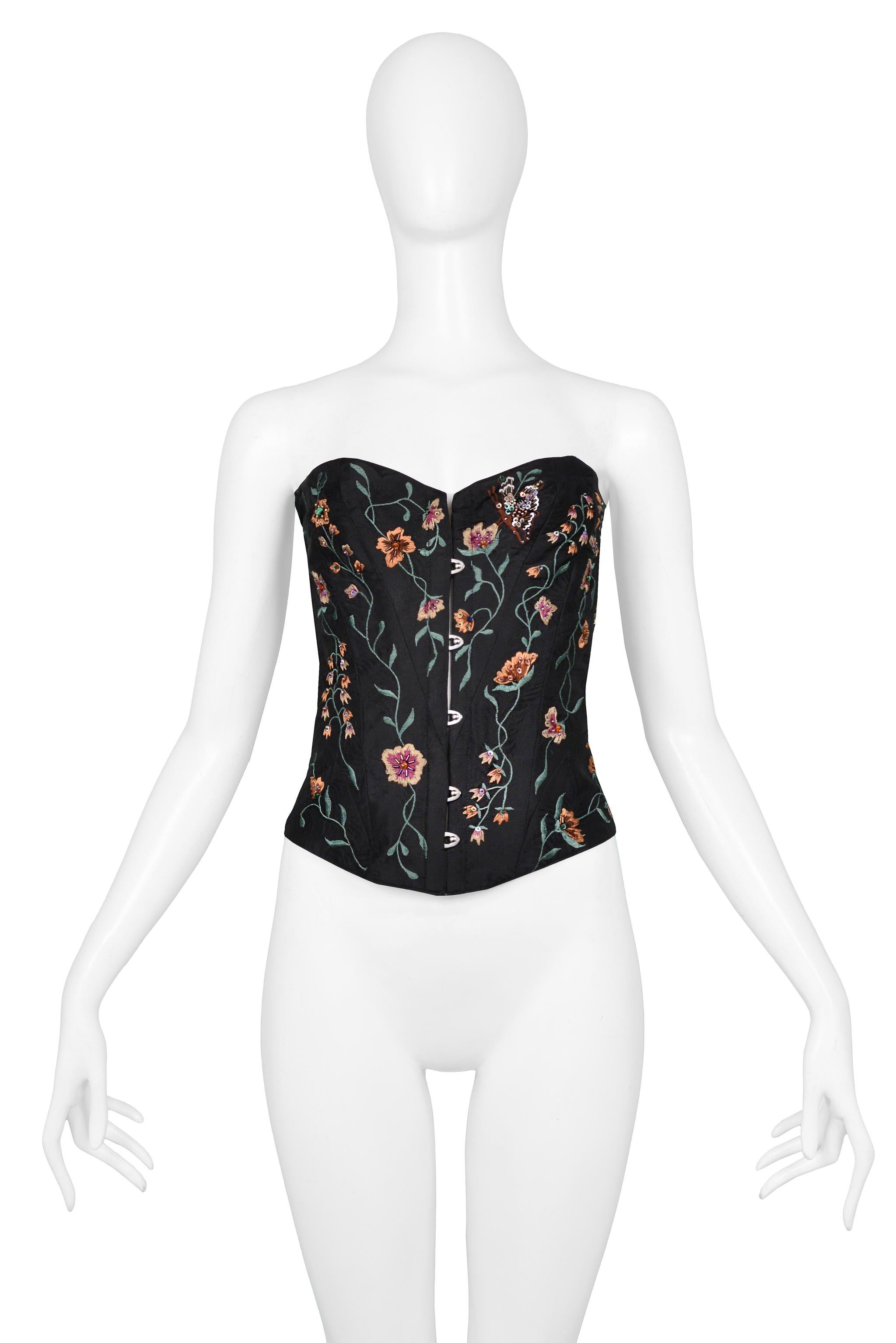 Resurrection Vintage is excited to offer a vintage Lolita Lempicka black bustier corset top with floral embroidery, beading and black satin ribbon laces in the back, and silk lining. 

Lolita Lempicka, Paris
Size: 42
Silk
2000 Runway