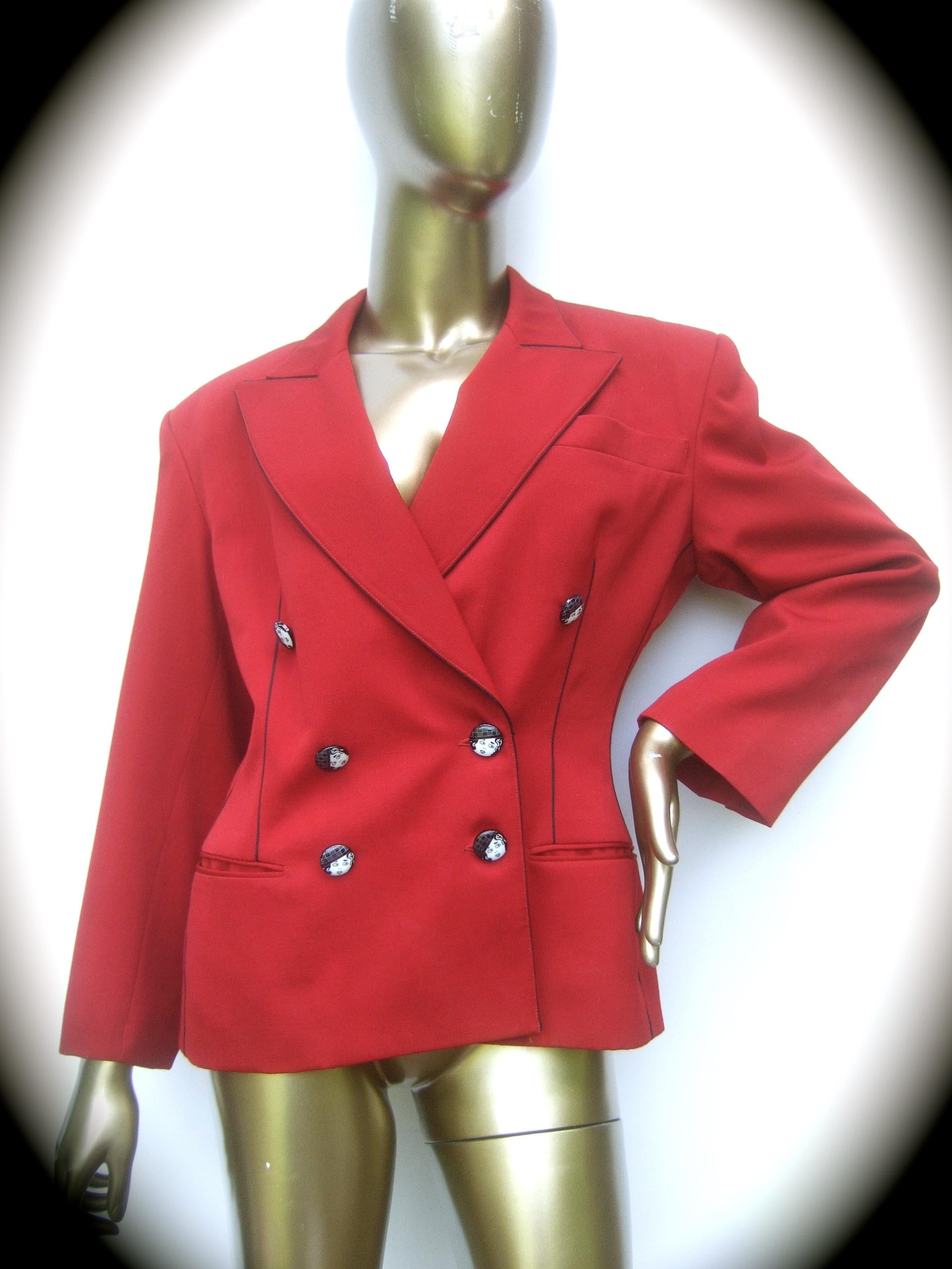 Lolita Lempicka Paris Red wool face button double-breasted blazer jacket French size 40 (vintage)

The stylish red laine wool jacket is adorned with a collection of black and white resin buttons depicting a retro style woman's face. The red laine
