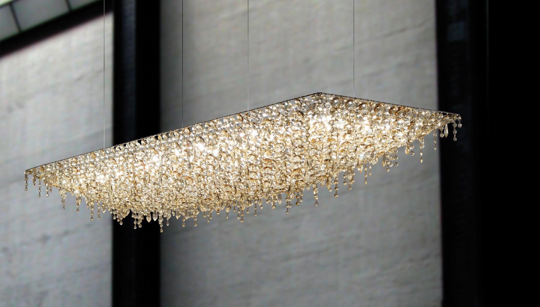 The Ugolino series is a collection of ceiling light fixtures made of handcut crystals woven together like a thick and layered embroidery of gems suspended from a disappearing frame. The unique technique creates modern and warm lighting pieces with