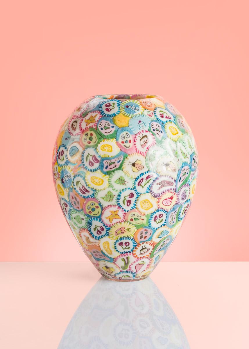Les vases à sucettes sont les pièces d'art les plus emblématiques d'Anna Jozova. C'est une réaction humoristique à la technique coûteuse et exigeante du verre de Murano. Les sucettes sont collées à l'intérieur de la forme en cristal soufflé à la