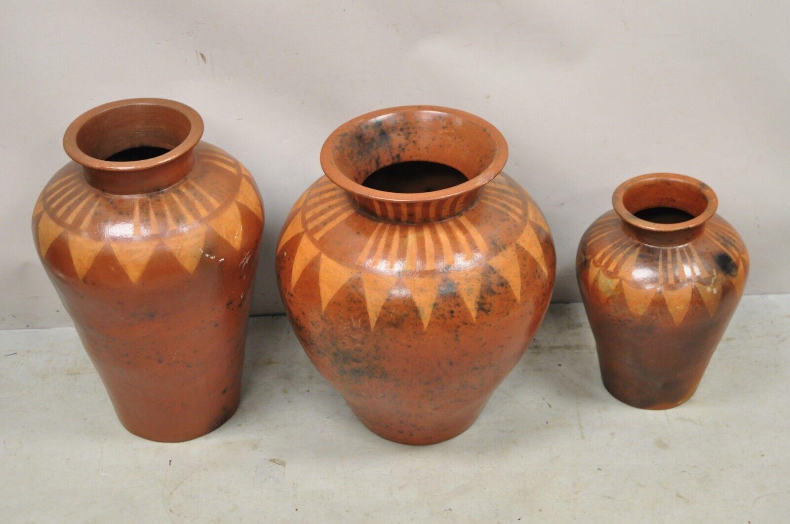 Lombok Crafts Indonesian Terracotta Clay Pottery Graduating Pot Jugs- Set of 3. Item features  3 graduating sizes, attractive fired finish, very nice set, quality craftsmanship, great style and form. Circa Late 20th Century.
Measurements: 
Large: