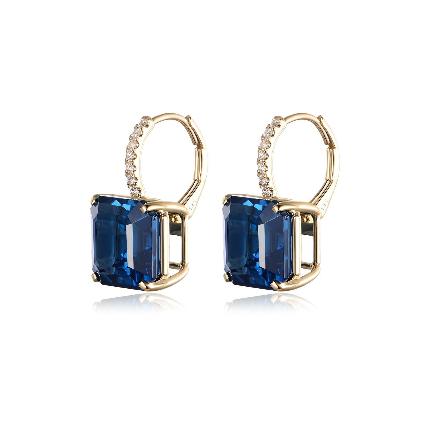 Die London Blue Topaz Drop Earrings verkörpern die Tiefe und das Geheimnis der Farben des Ozeans und sind ein Beweis für raffinierte Eleganz. In der warmen Umarmung von 14-karätigem Gelbgold sind die Ohrringe mit einem majestätischen Blautopas von