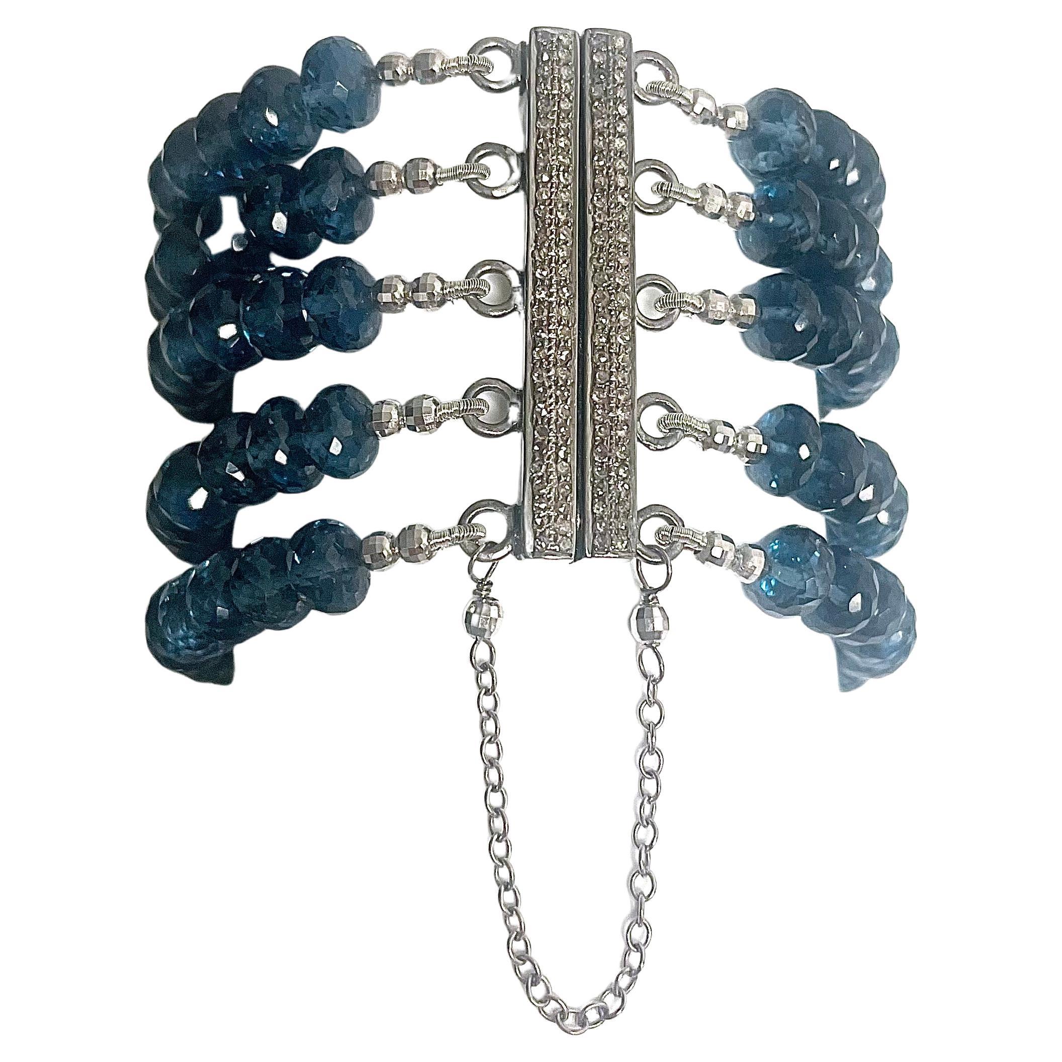 Description
The rich and exquisite London Blue color of this five strand quartz bracelet doesn’t go unnoticed and makes a bold statement with its unusual pave diamond centerpiece. The bracelet is secured with a unique pave diamond magnetic clasp for