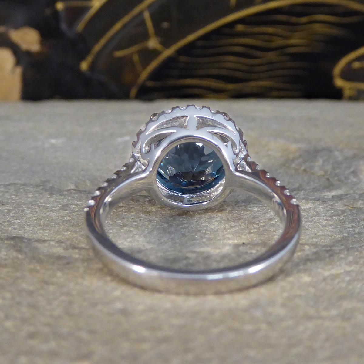 Brilliant Cut London Blue Topaz and Diamond Halo Cluster Ring in Platinum with Diamond set Sho For Sale