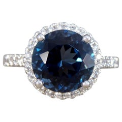 Bague London en platine, topaze bleue et halo de diamants sertis