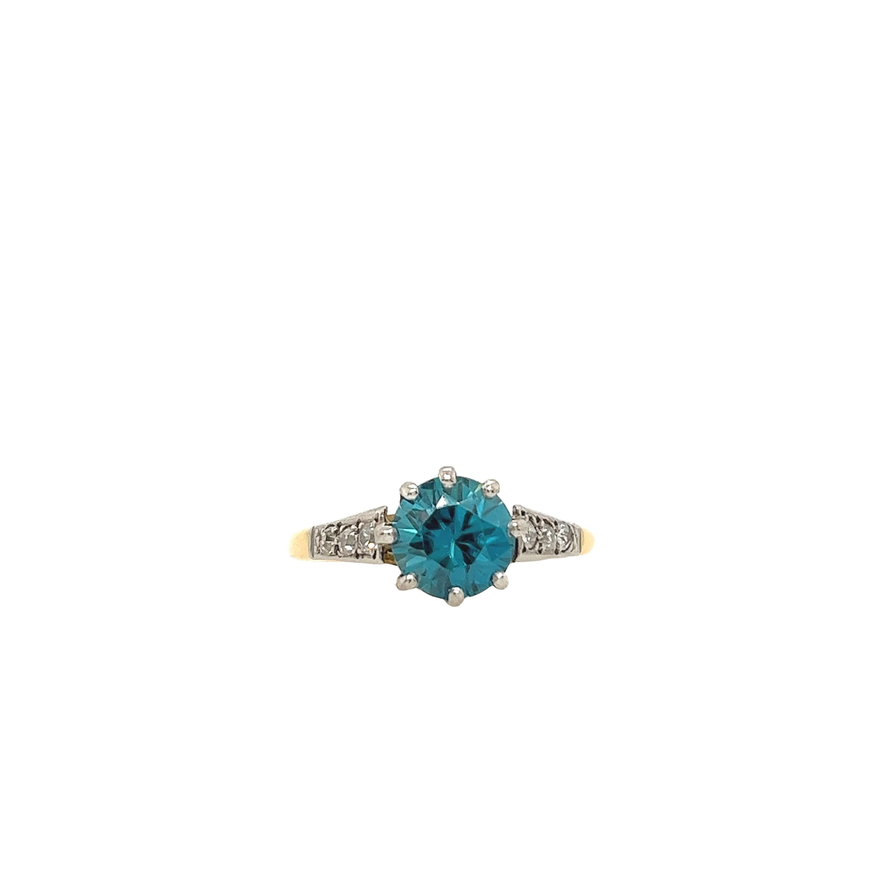 Classic fine quality London blue topaz ring with 6 rose cut diamonds on the shoulders. Total diamond weight is 0.12ct.  Set in exquisite 18ct yellow and white gold.

Total Weight: 3.5g
Ring Size: L1/2
Width of Band: 1.47mm
Width of Head: